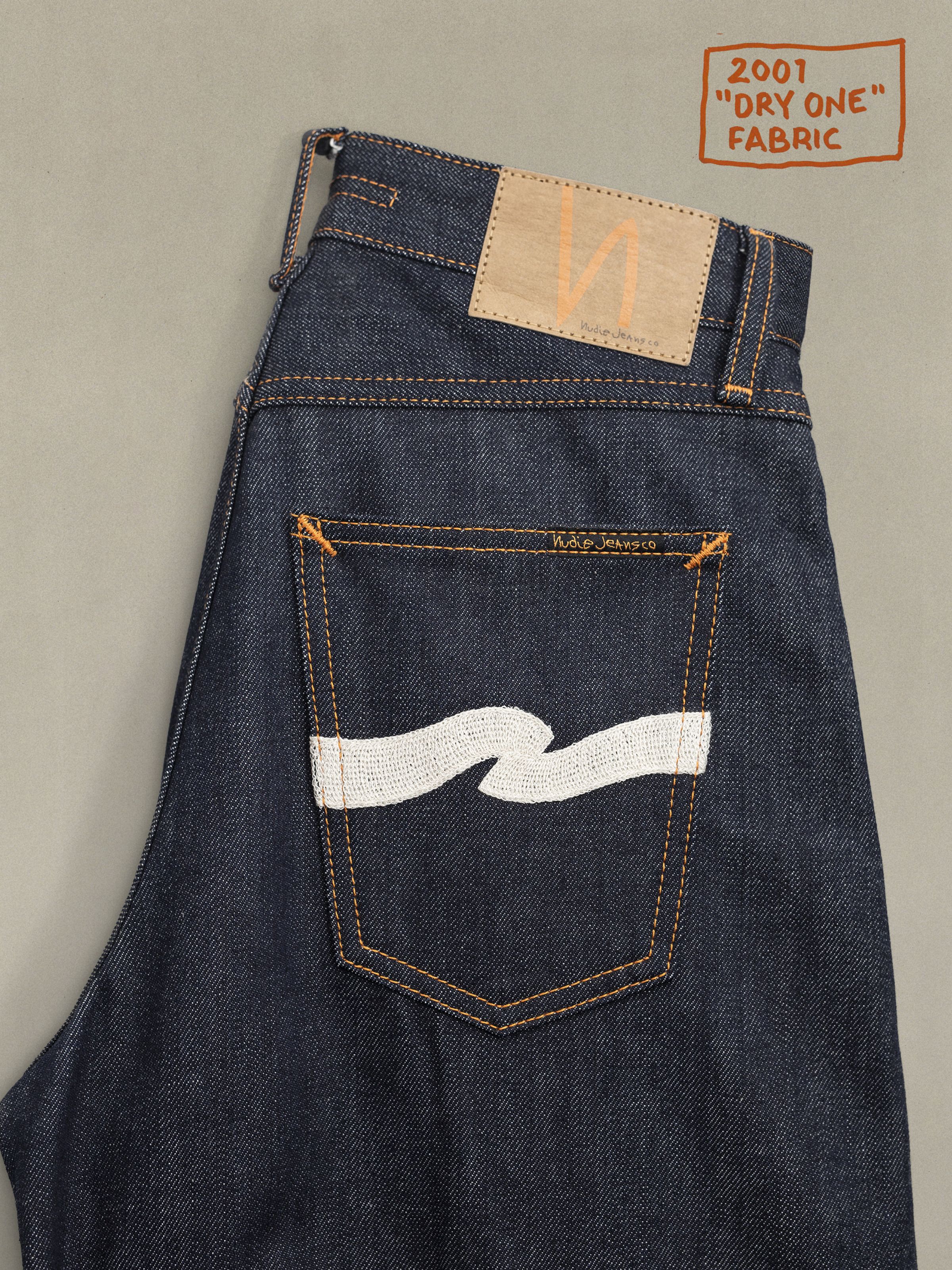 Nudie Jeans Sonic Sue Dry Ecru Waves back pocket detail with ecru waves embroidery on rigid indigo organic cotton denim.