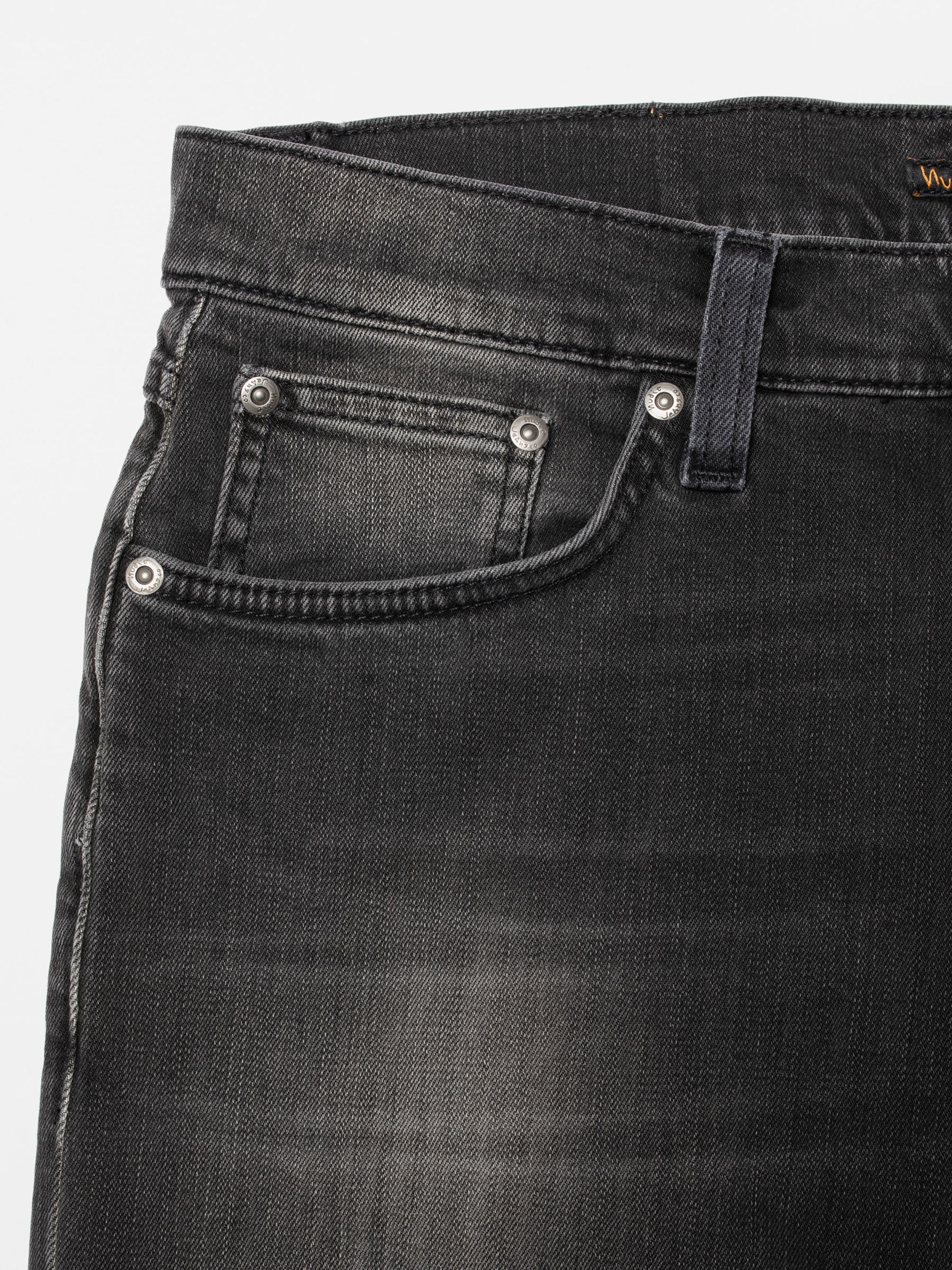 Nudie Jeans Solid Ollie Black Mist, close-up of the front pocket in washed black organic cotton comfort stretch denim.
