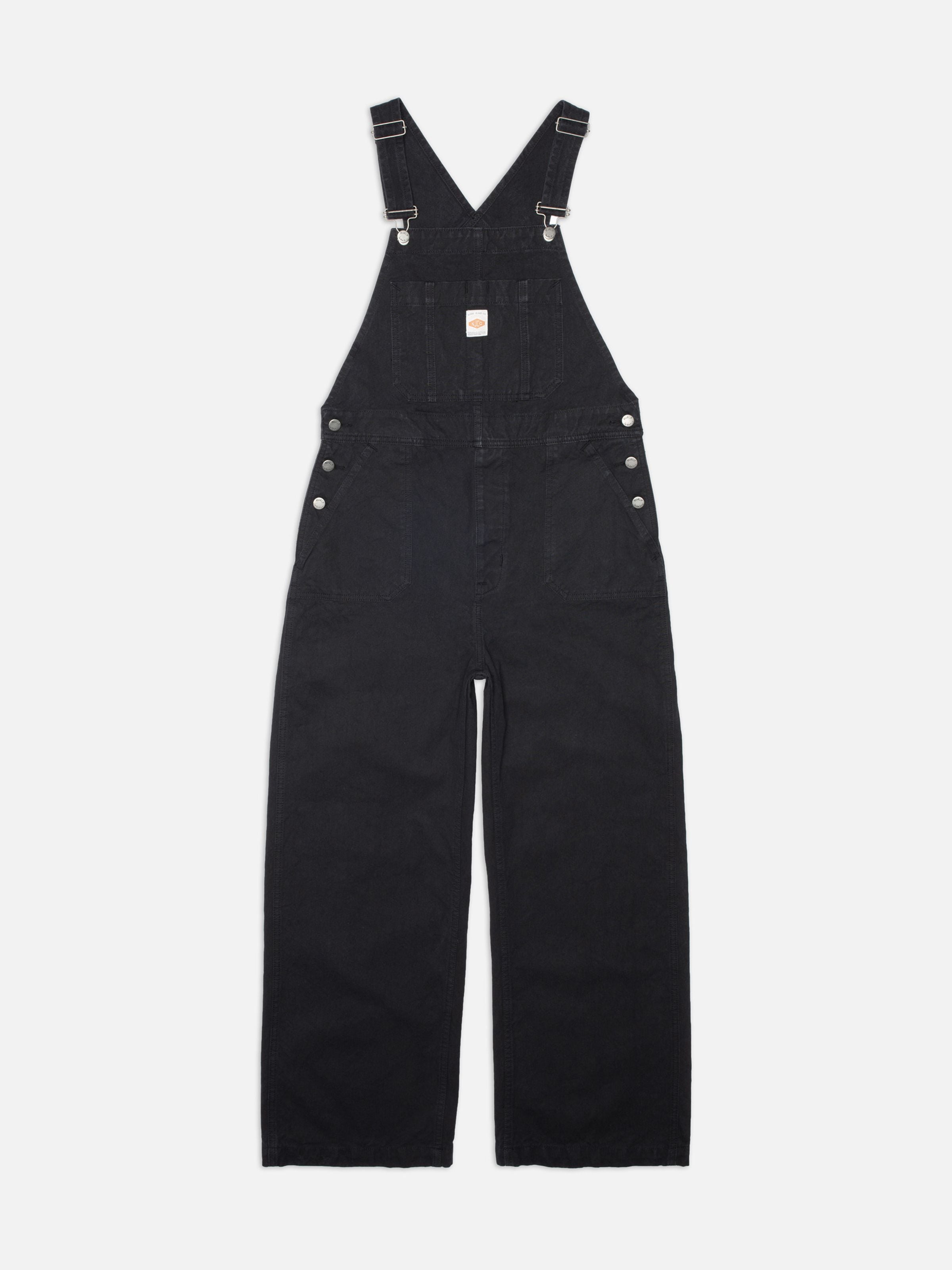 Nudie Jeans Klara Dungarees Duck Canvas, women's regular fit dungarees in black, shown laid flat against a white background.
