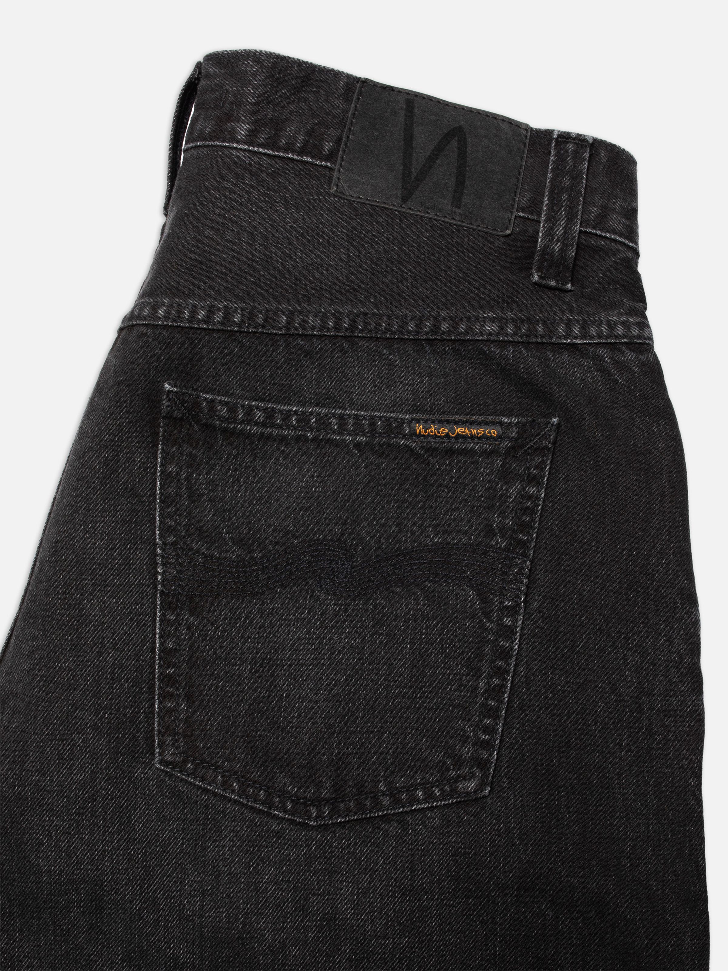 Nudie Jeans Zeb Denim Shorts Night Dune, close-up of the back pocket showing tonal black stitching and leather patch.