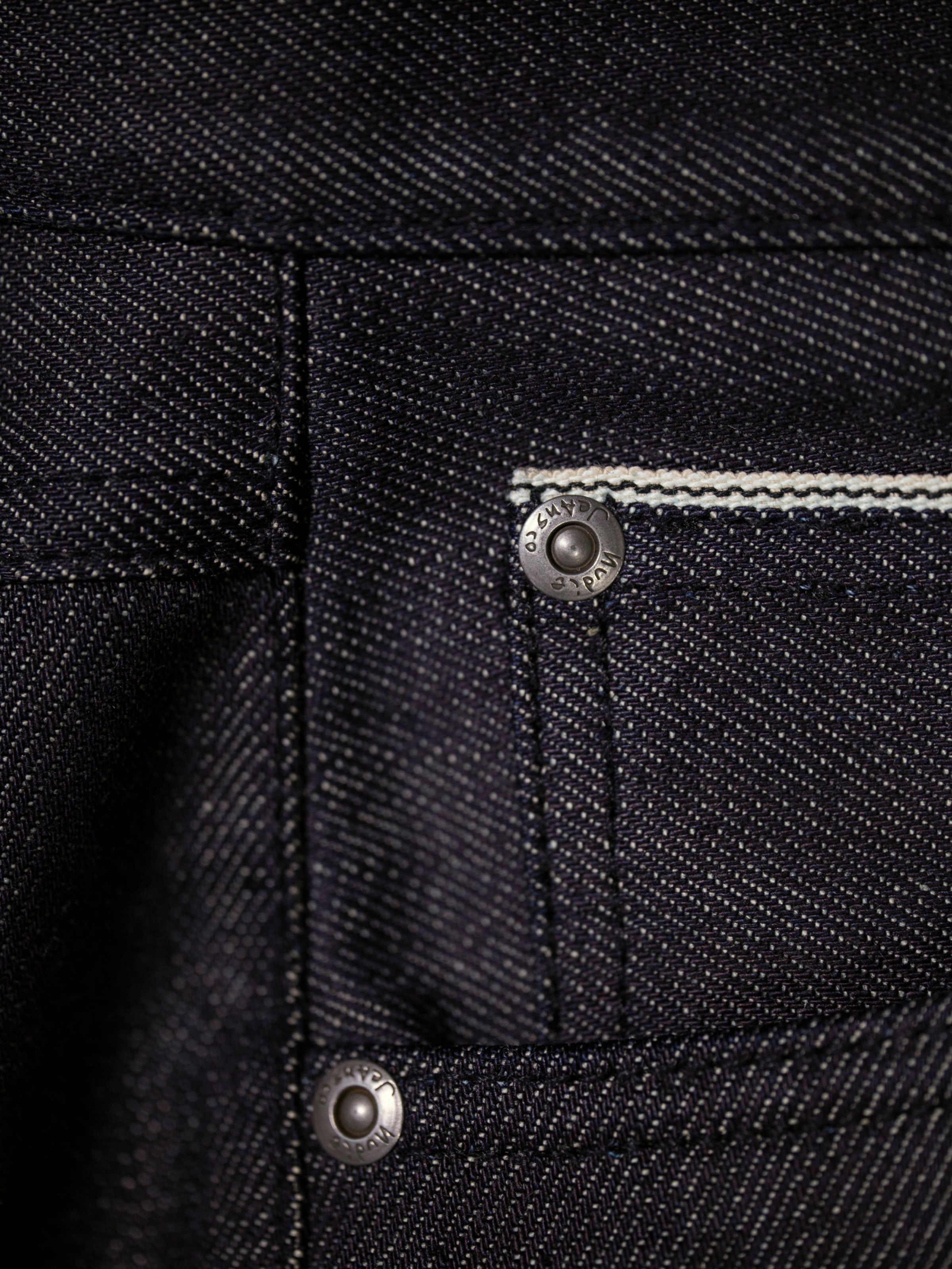 Nudie Jeans Solid Ollie Dry Eclipse Selvage, men's slim straight fit jeans, showing close-up of the coin pocket selvedge ID.
