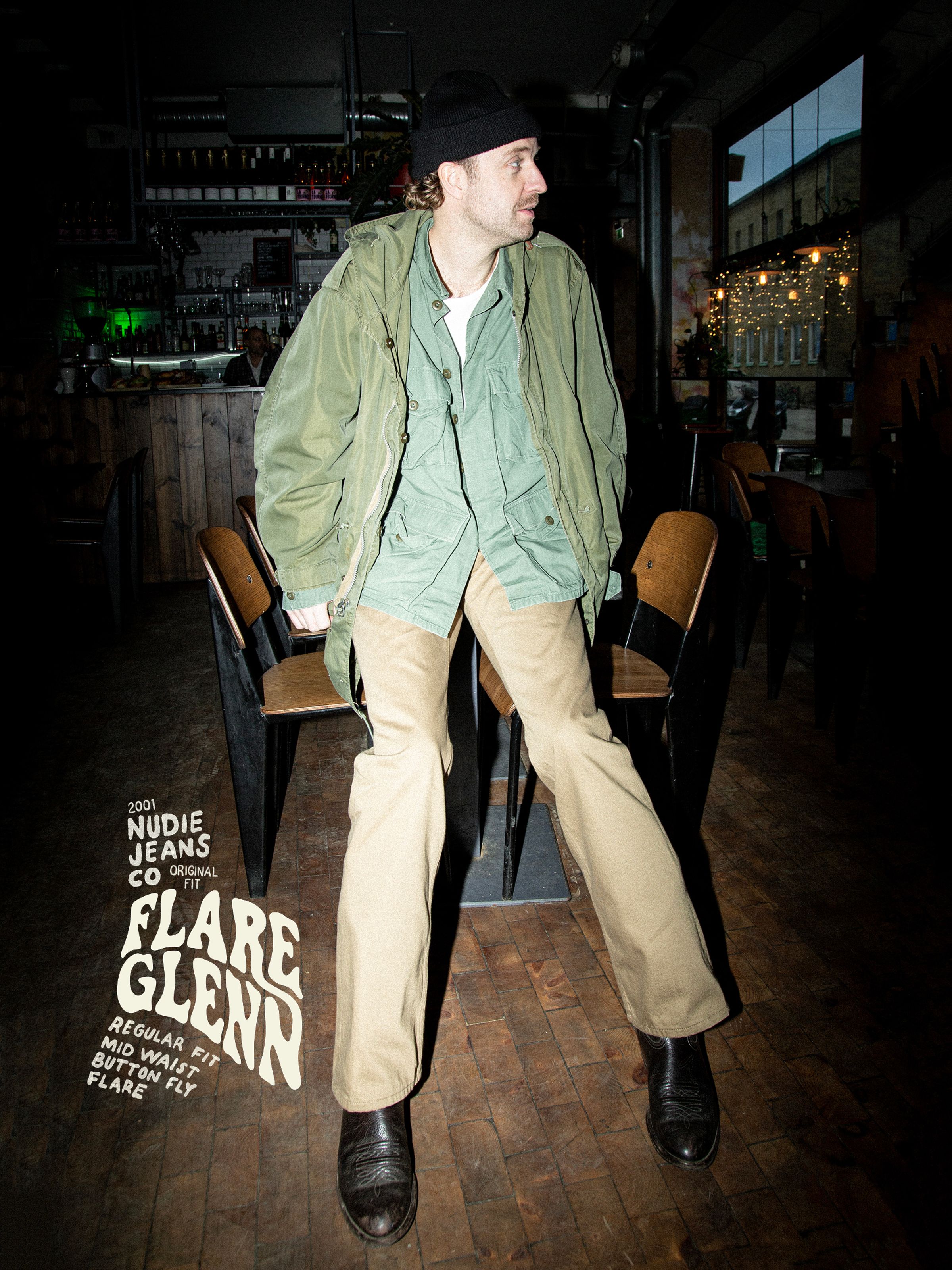 Nudie Jeans Flare Glenn Everlion, men's regular fit flared jeans, shown on a model in a bar setting.
