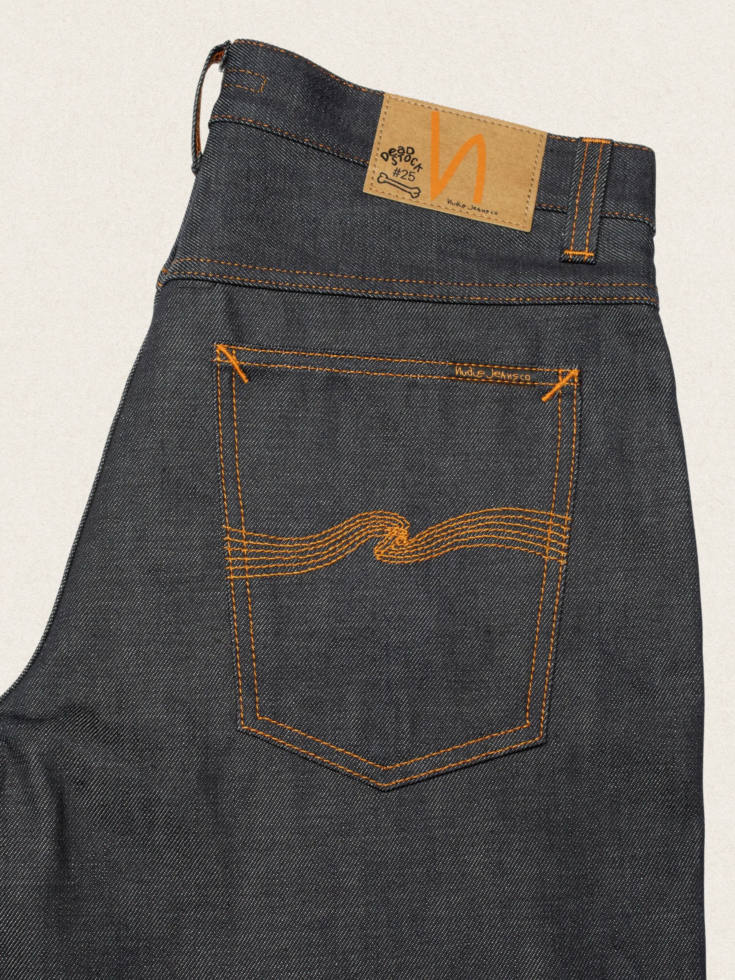 Nudie Jeans Loud Larry Deadstock 25, men's loose fit jeans, close-up of the back pocket and jacron patch.