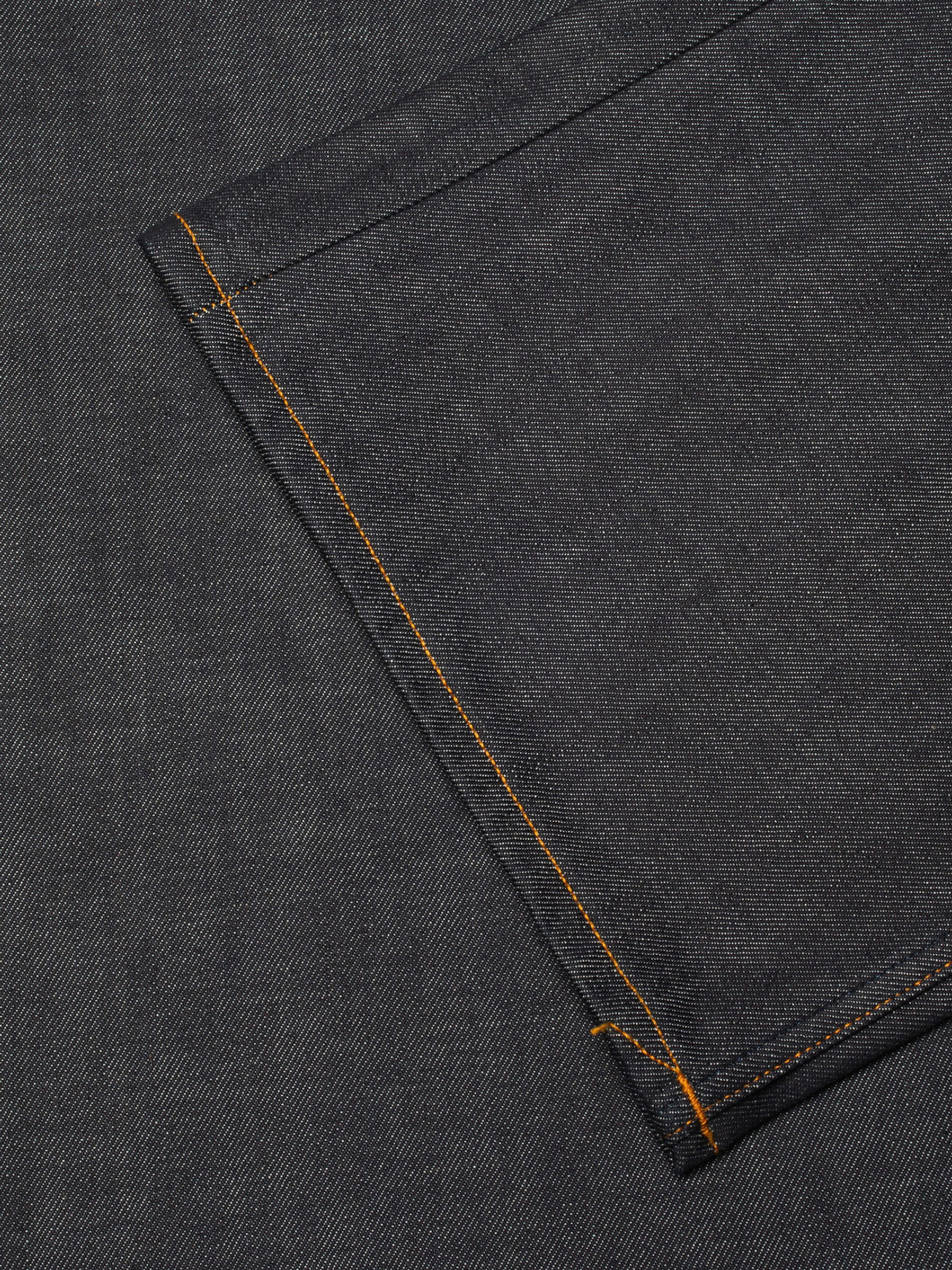 Nudie Jeans Loud Larry Deadstock 25, men's loose fit jeans, close-up of the back pocket showing the orange stitching.