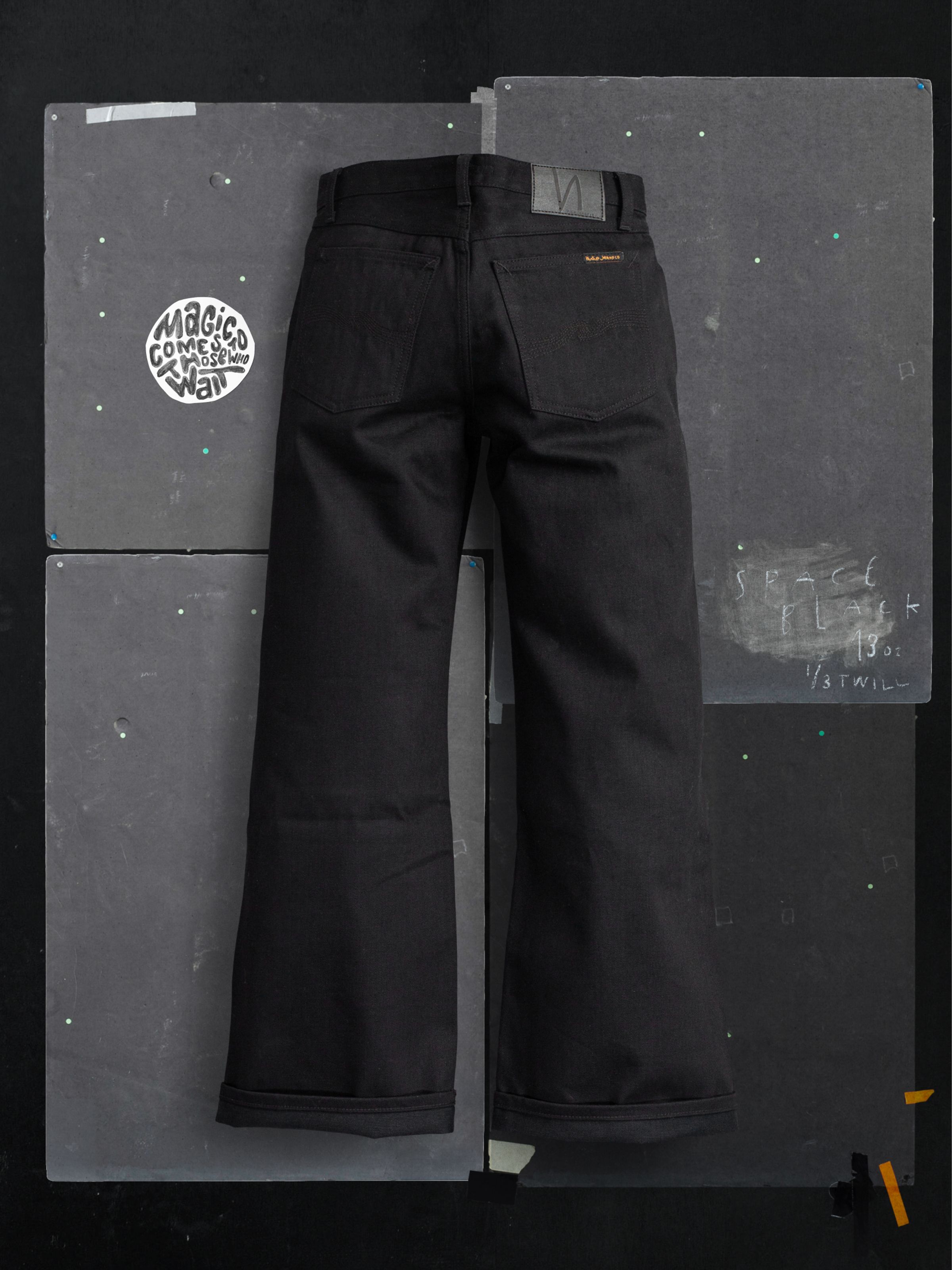 Nudie Jeans Wide Heidi Space Black Selvage, wide-leg jeans in rigid black selvedge denim shown from the back.