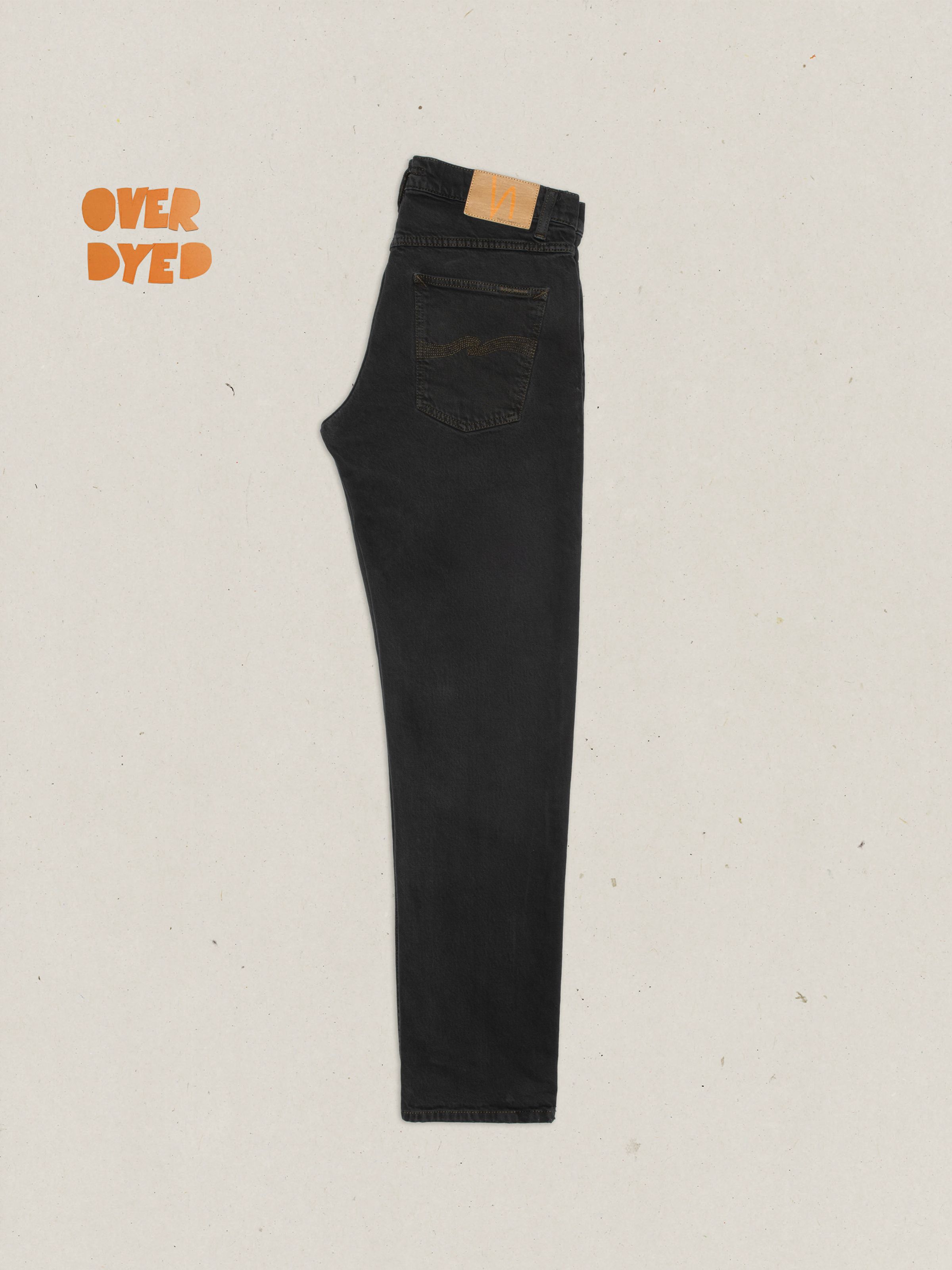 Nudie Jeans Solid Ollie Petrol Black, overdyed slim-fit jeans shown from the side in a flat lay view.