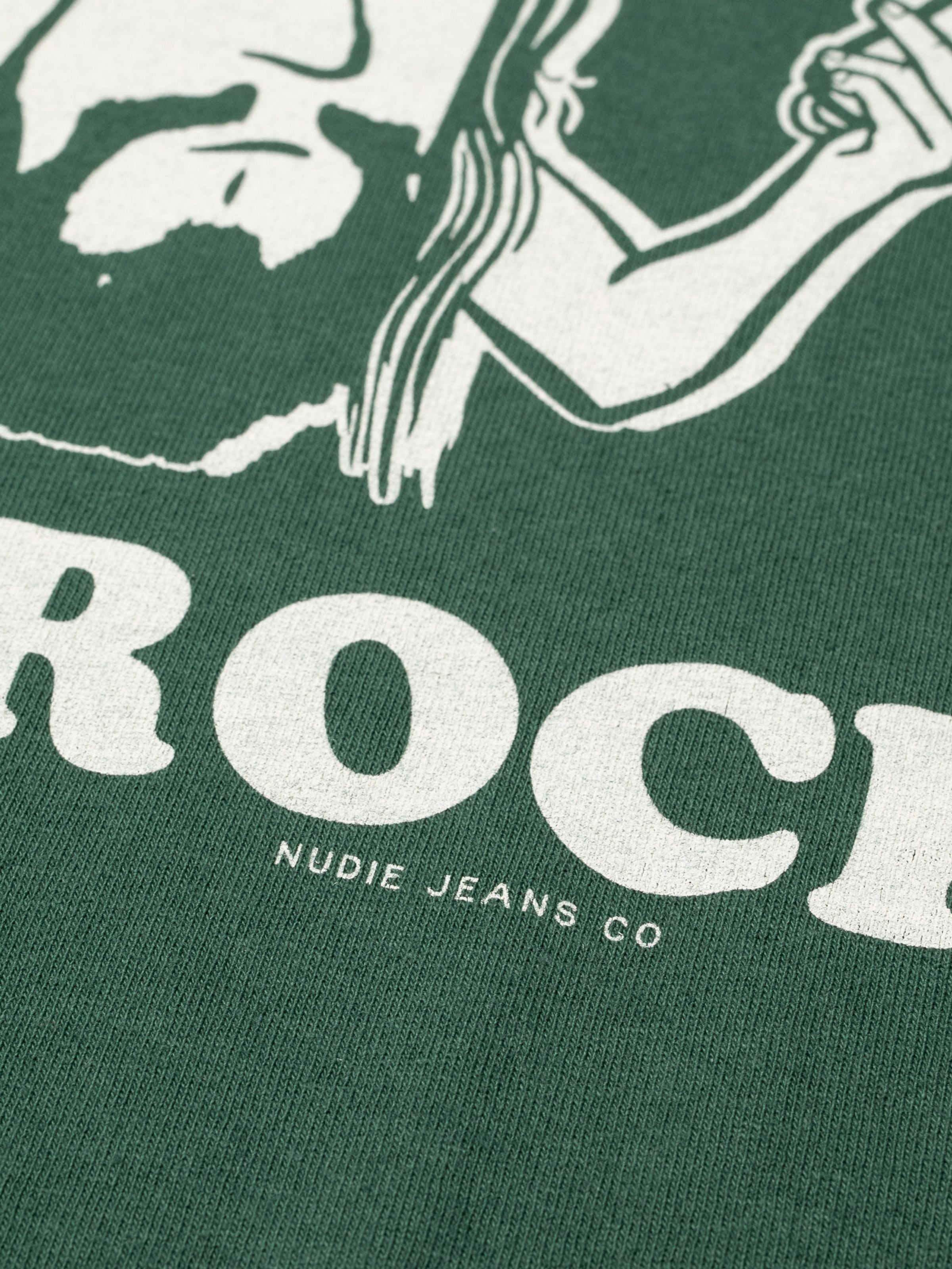 Nudie Jeans Roy Short T-Shirt Cowbell, close-up of the graphic print and organic cotton texture in green.
