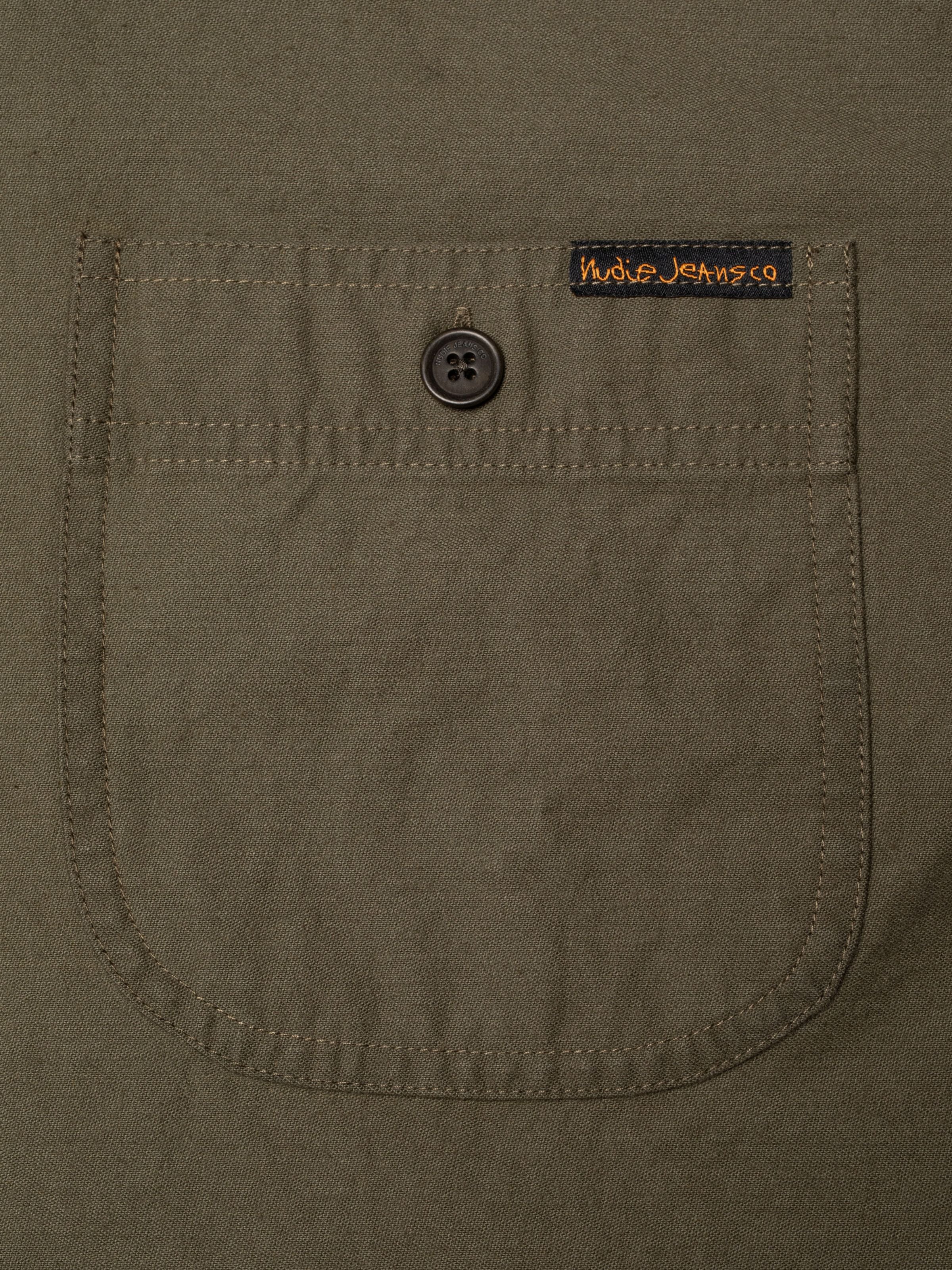 Nudie Jeans Julian Shirt Back Sateen in Olive Green, showing a close-up of the chest pocket and corozo button.