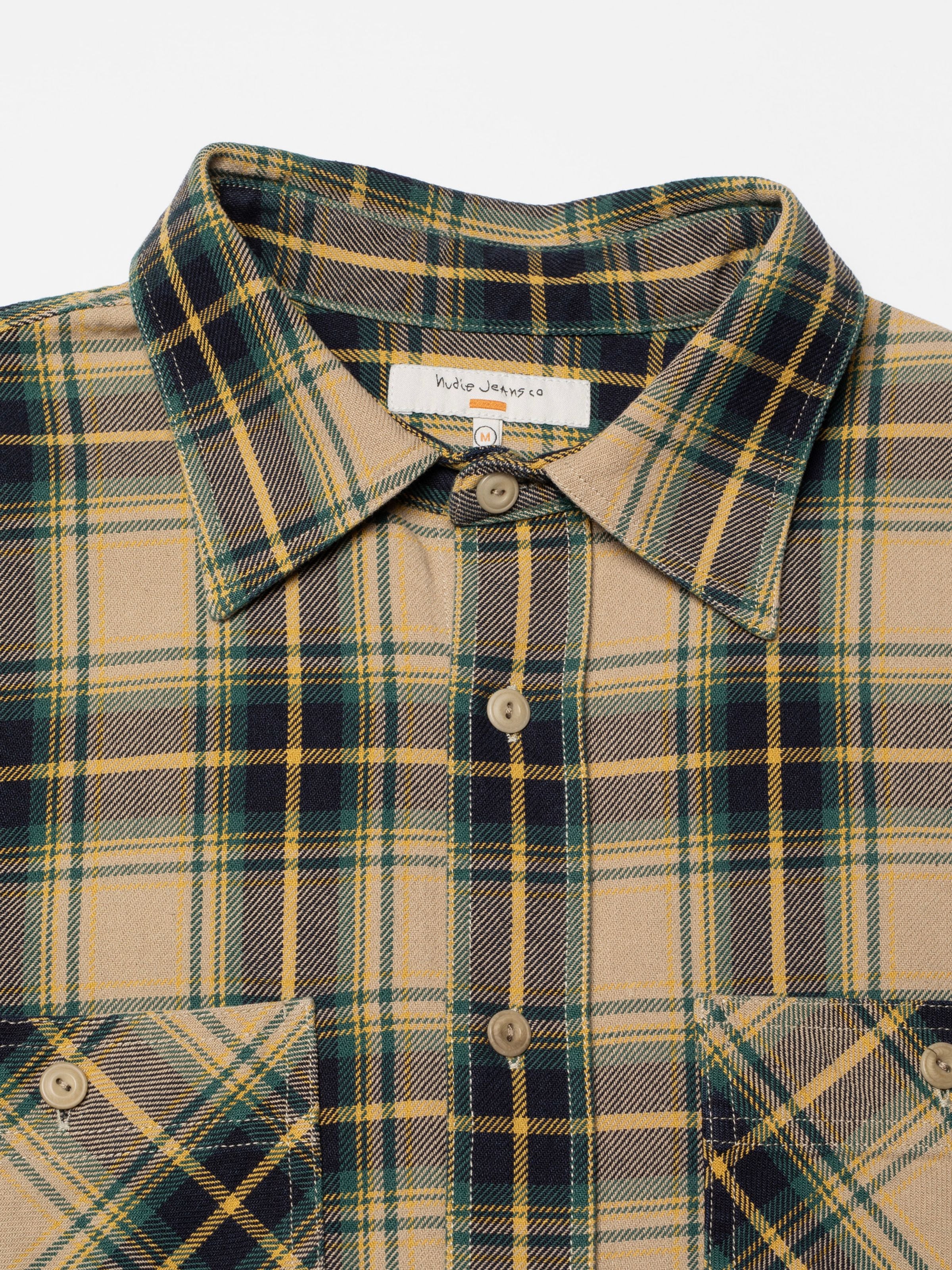 Nudie Jeans Julian Shirt Tartan Check, close-up of the tartan pattern, corozo buttons, and collar label.