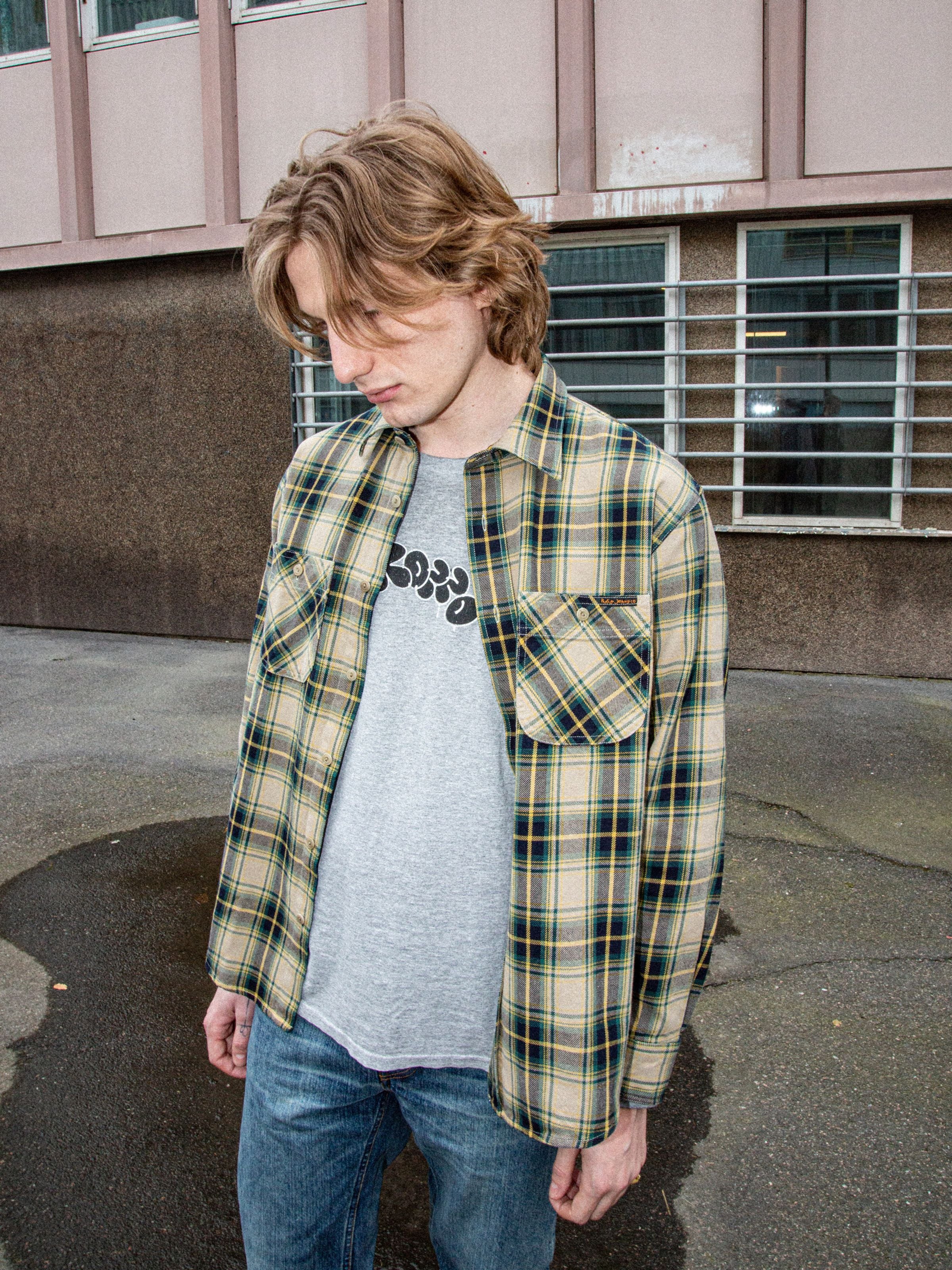 Nudie Jeans Julian Shirt Tartan Check, organic cotton long-sleeve shirt in multi tartan, shown in a lifestyle shot.