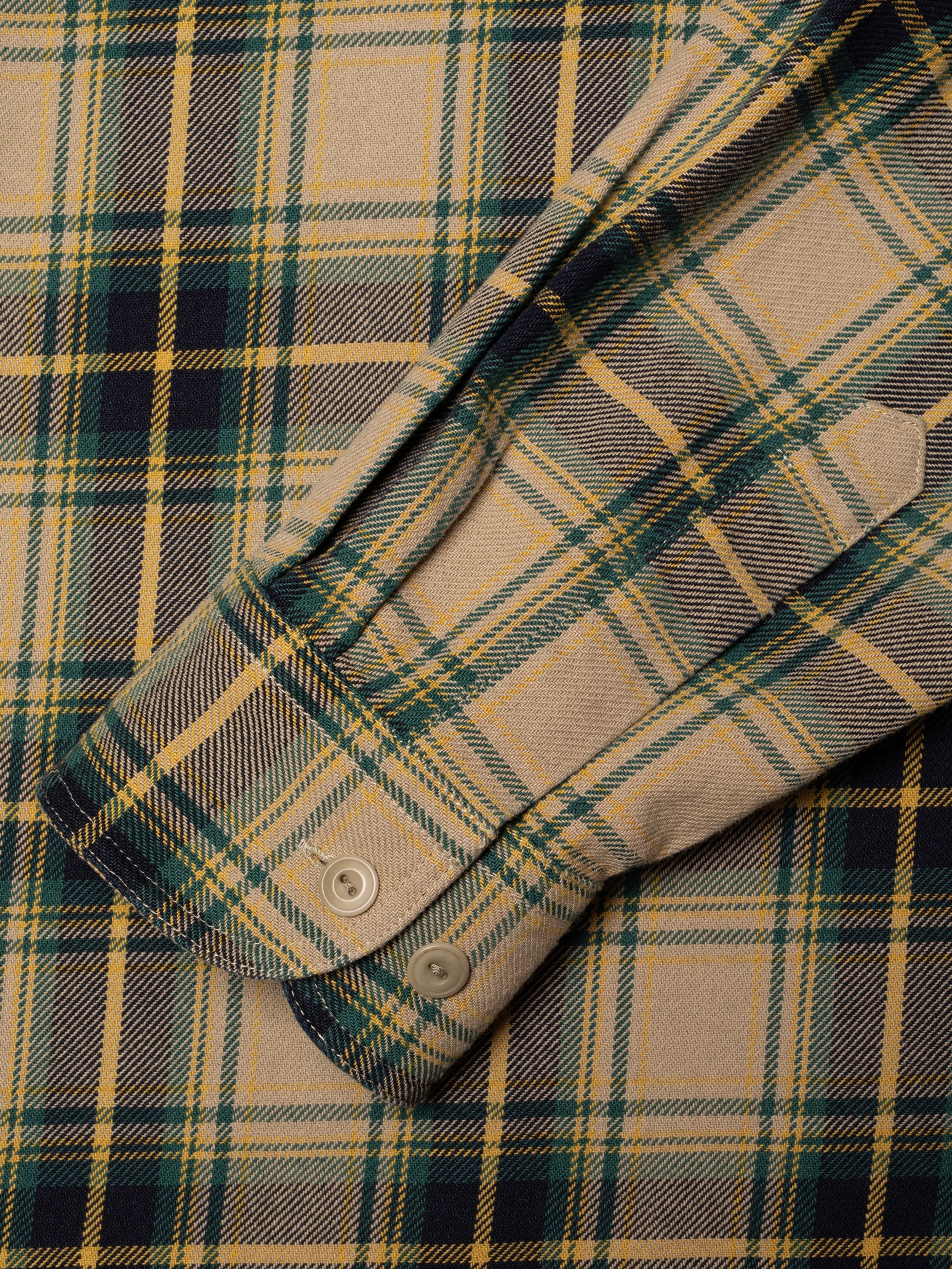Nudie Jeans Julian Shirt Tartan Check, close-up of the cuff and green, navy, and yellow tartan check twill fabric.