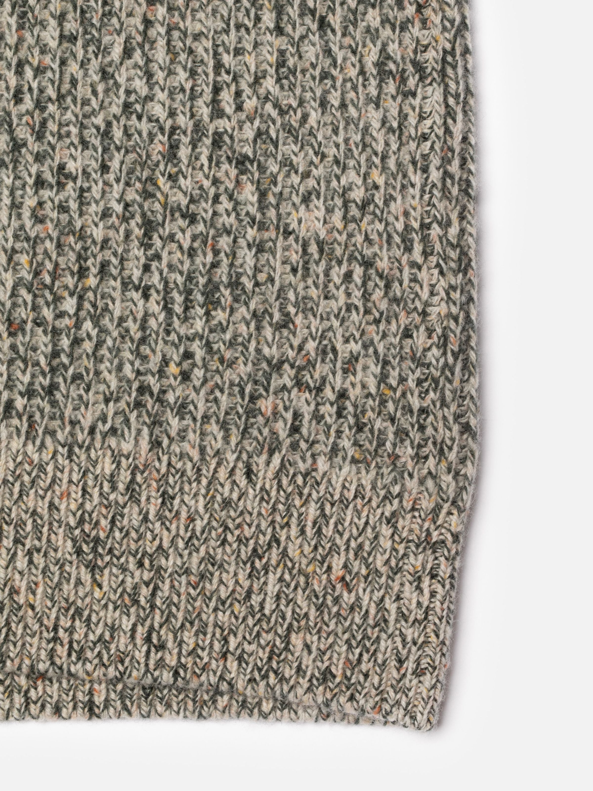 Nudie Jeans August Rib Wool Sweater in Green Melange, close-up of the textured organic wool knit fabric.