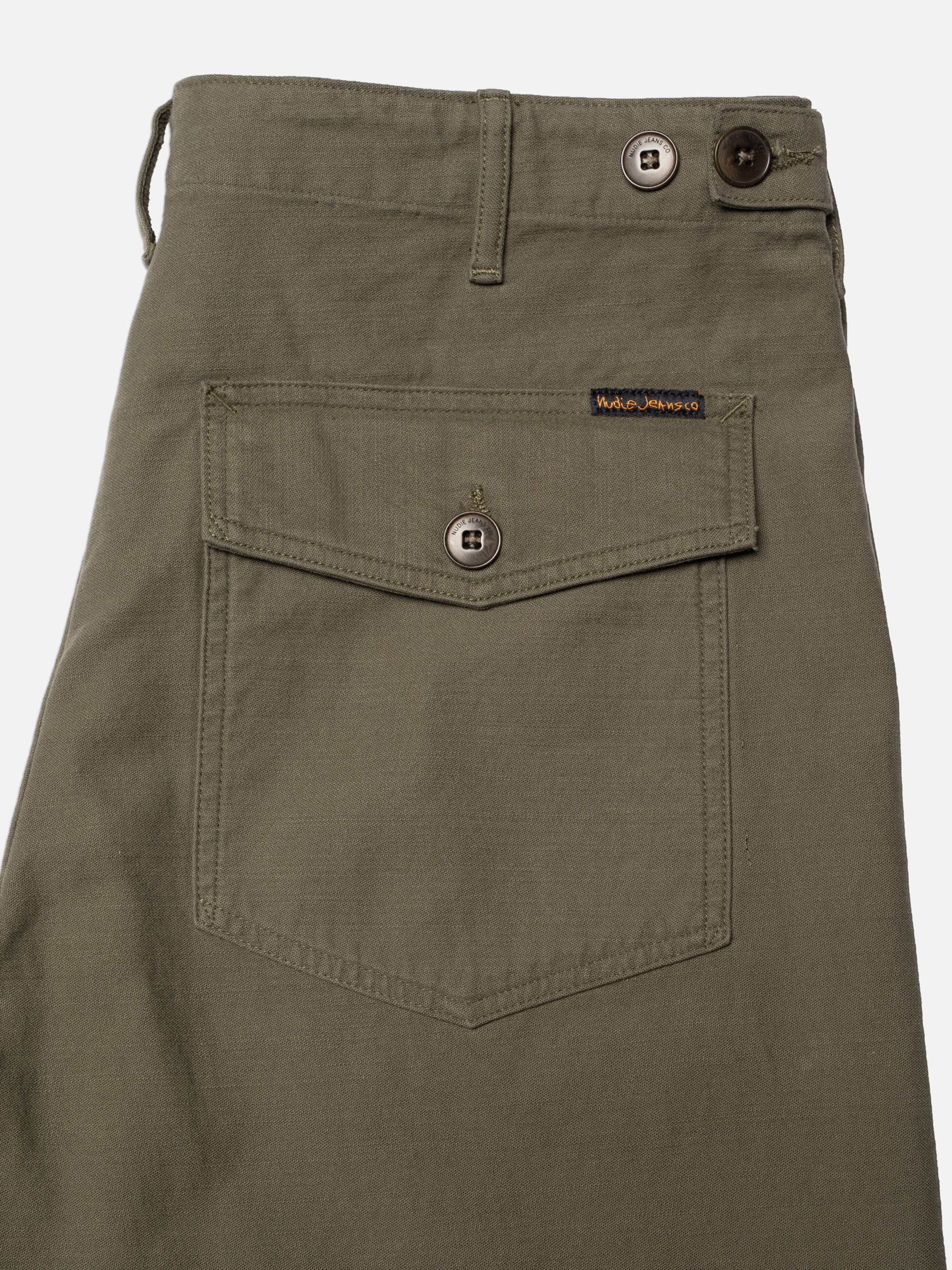 Nudie Jeans Tuff Tony Pants BS Olive Green, showing a close-up of the back pocket and organic cotton sateen texture.
