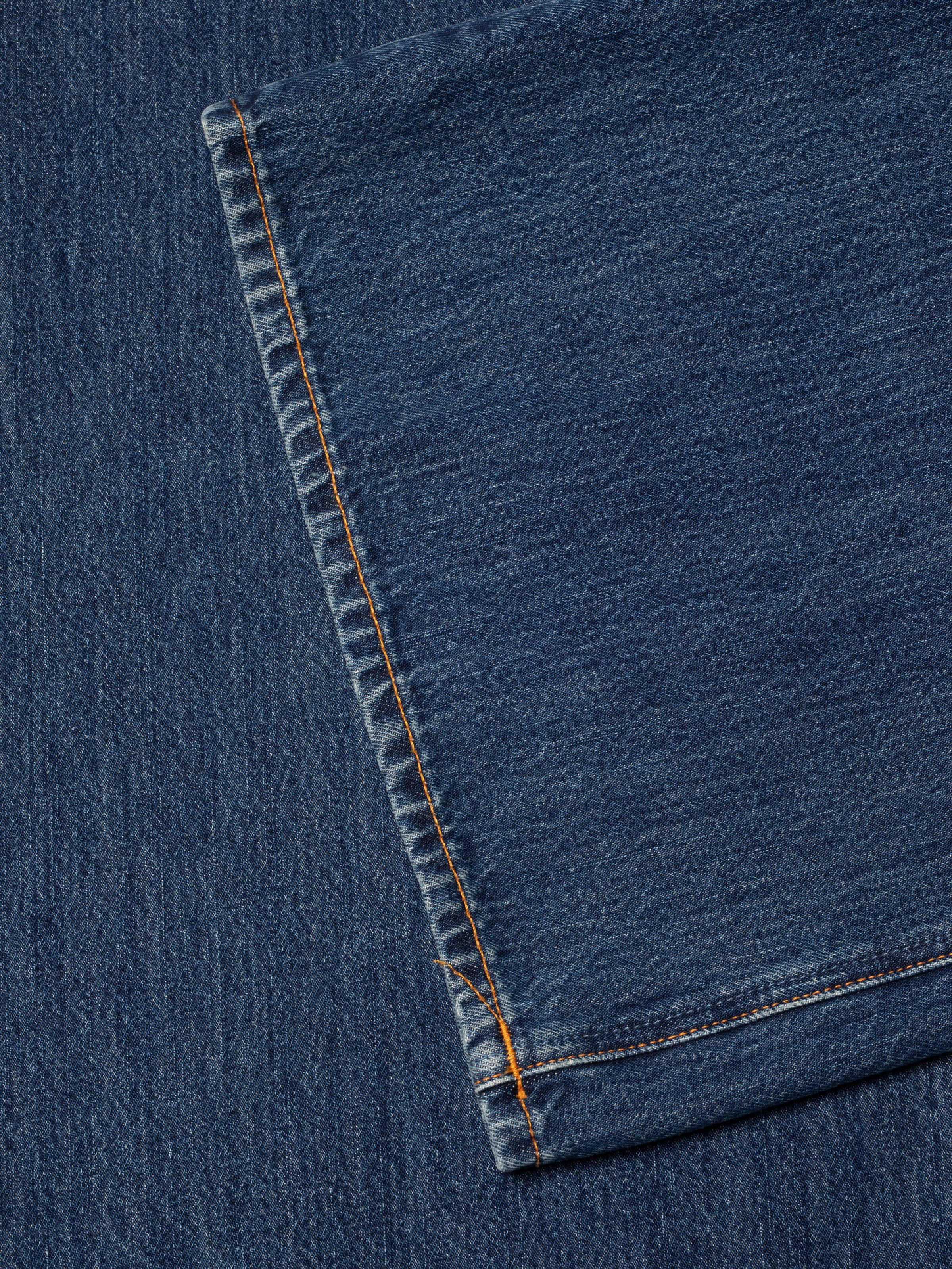 Nudie Jeans Sonic Sue Blue Poem, loose fit jeans, showing a close-up of the outer seam and organic cotton denim texture.
