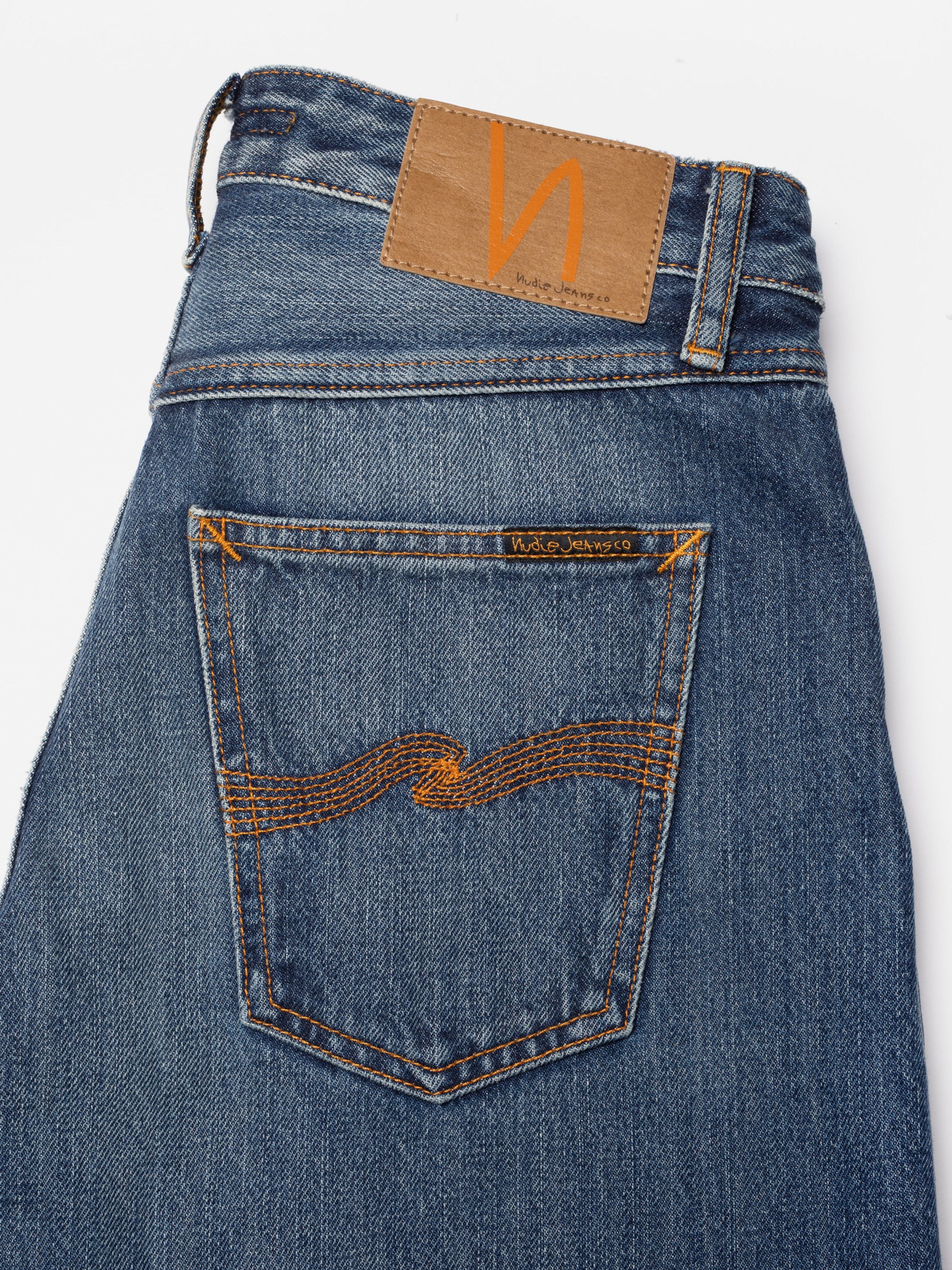 Nudie Jeans Sonic Sue Blue Poem, women's loose fit jeans, showing a close-up of the back pocket, patch, and denim wash.