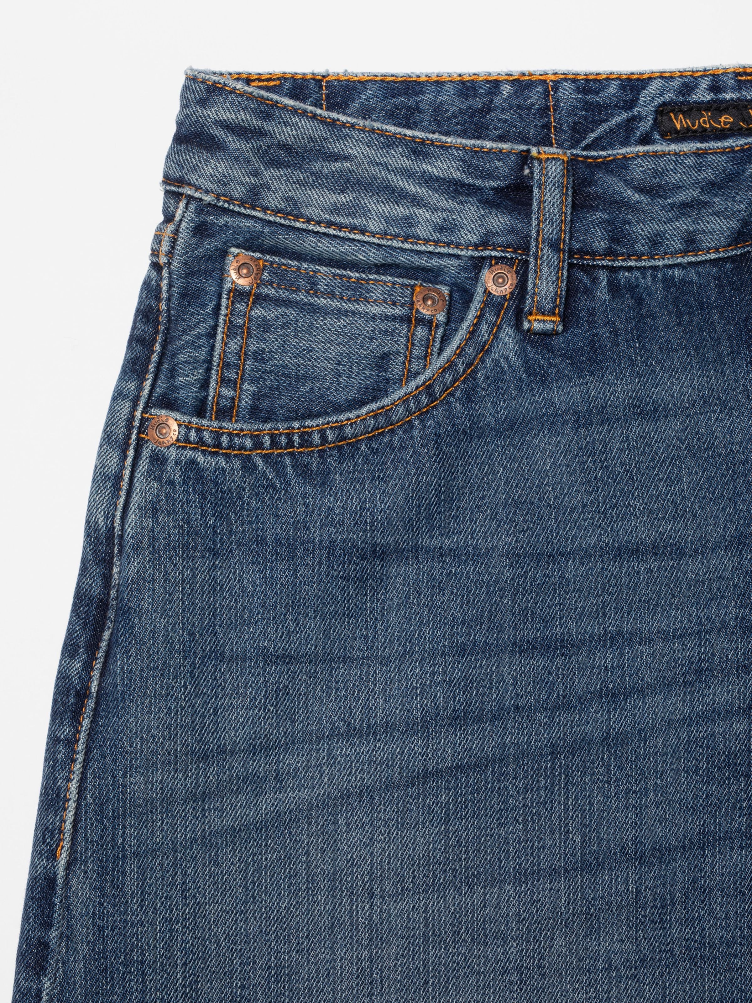 Nudie Jeans Sonic Sue Blue Poem, women's loose fit jeans, showing a close-up of the front pocket and washed denim texture.