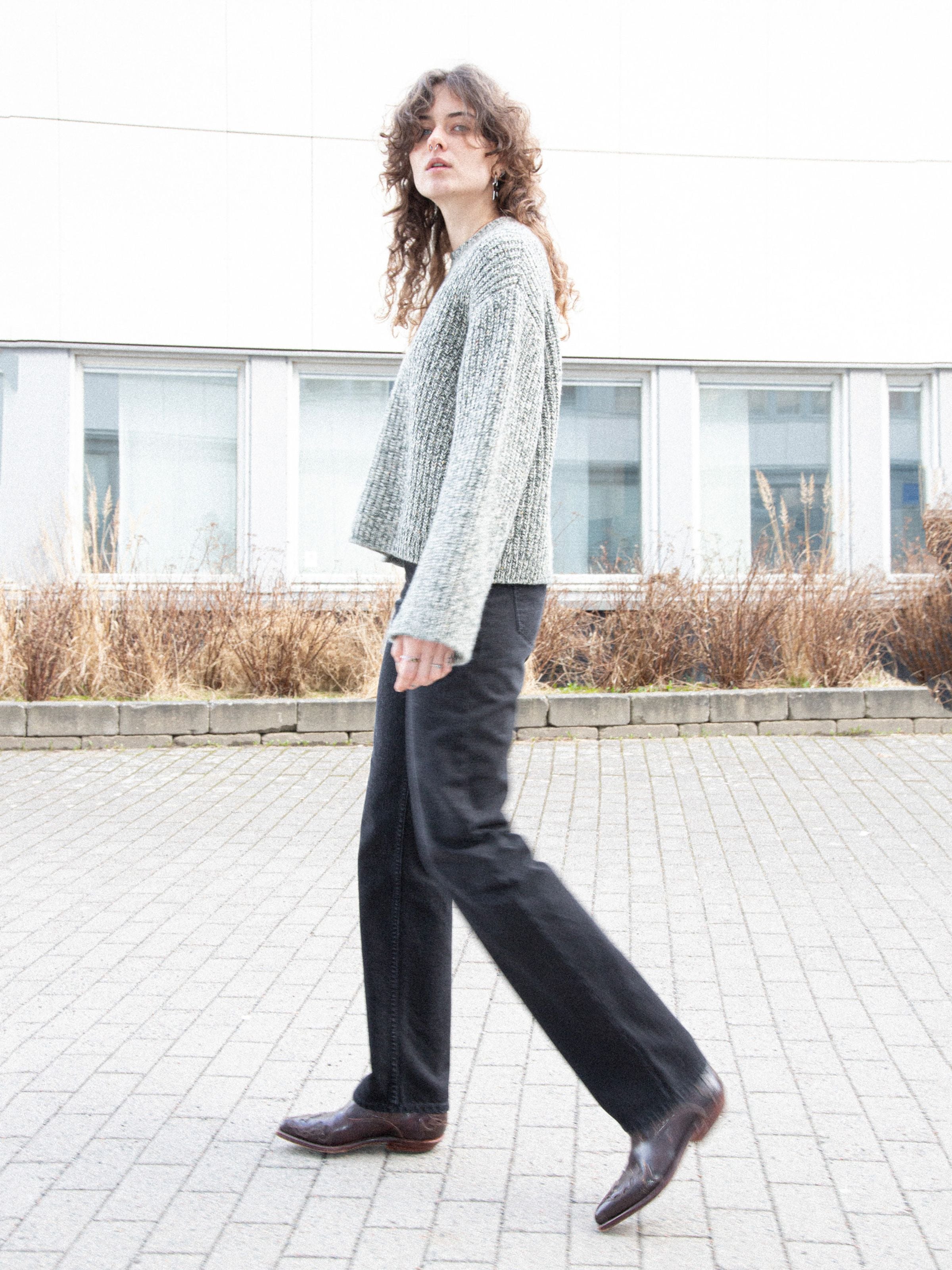 Nudie Jeans Sharp Charlie Midnight Ash, women's straight leg jeans in black, shown worn outdoors with a knit sweater.