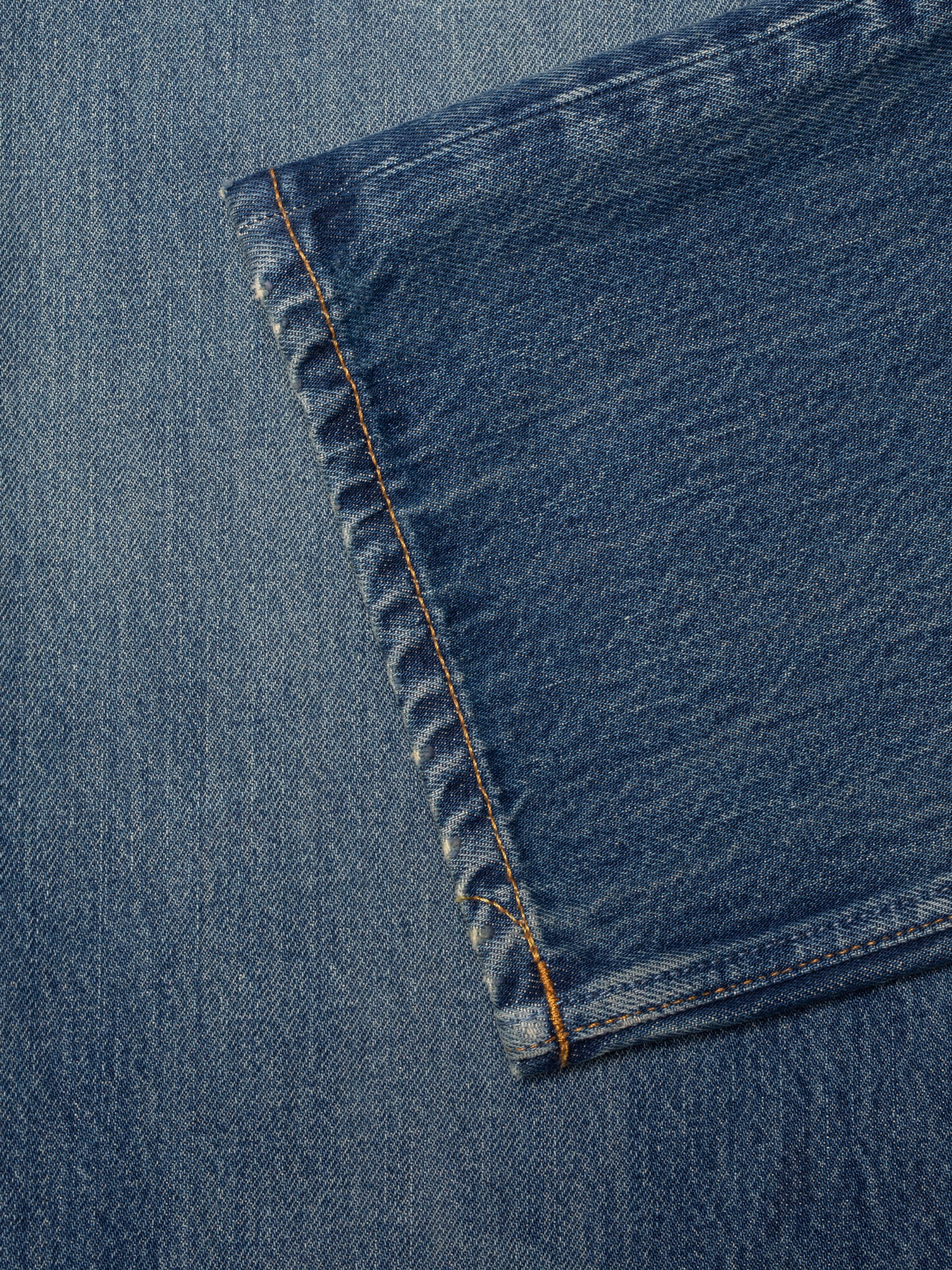 Nudie Jeans Sharp Charlie Gravel Stone, women's straight leg jeans, showing a close-up of the hem and denim texture.