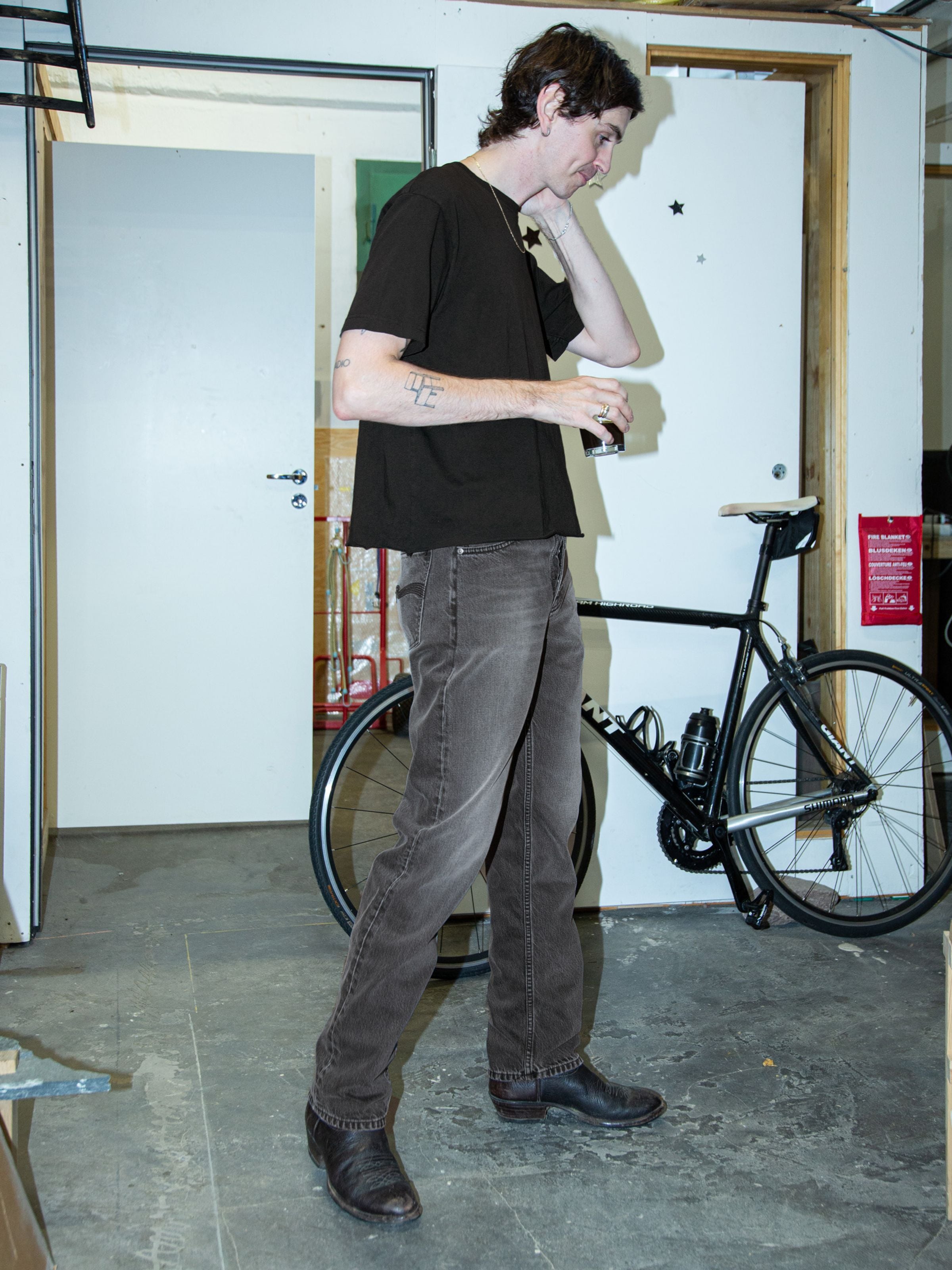 Nudie Jeans Rad Rufus Grey Lake, men's straight fit jeans in washed grey organic cotton denim, shown worn indoors.