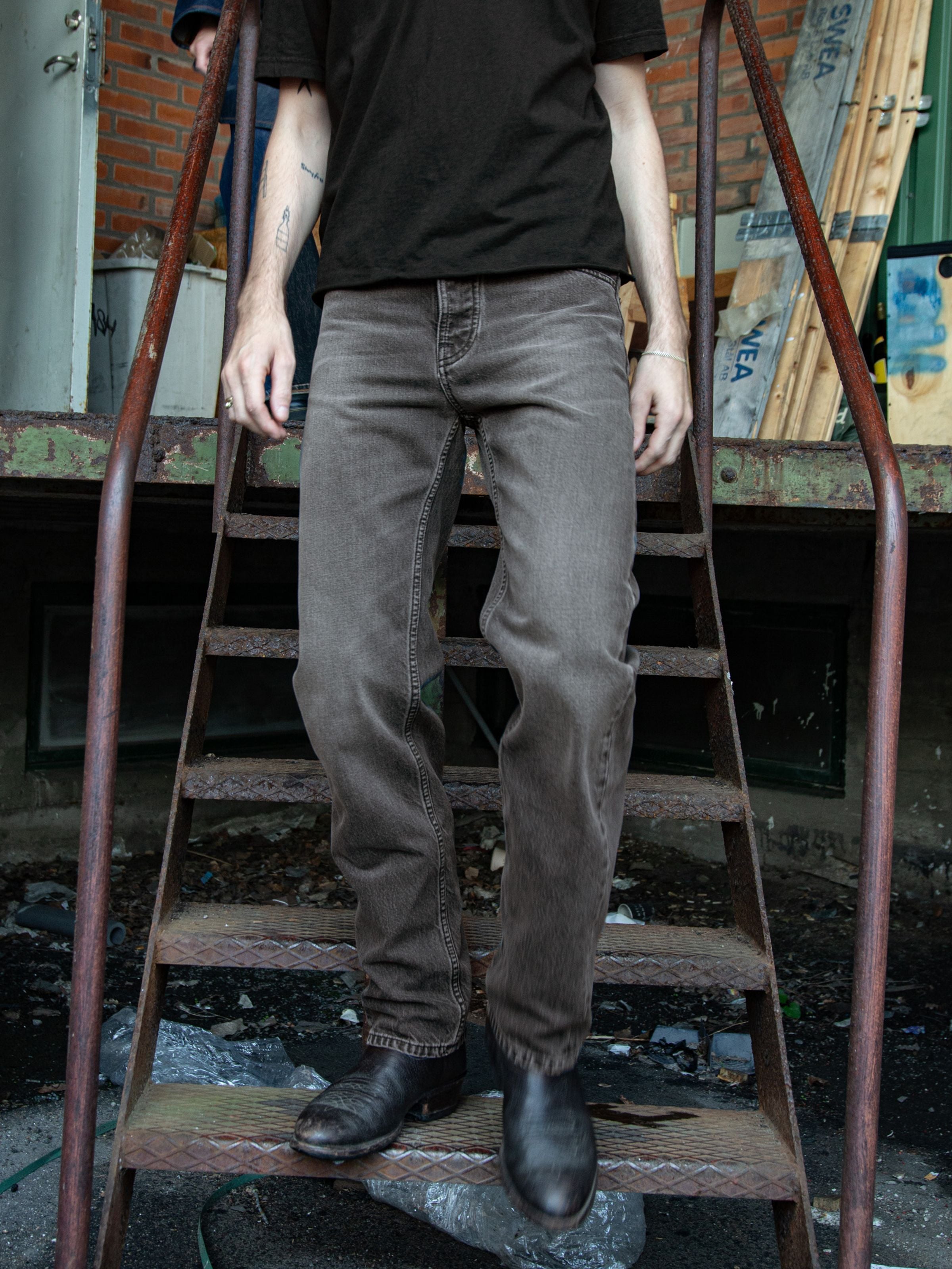 Nudie Jeans Rad Rufus Grey Lake, regular fit jeans in grey wash organic cotton denim, lifestyle shot on stairs.