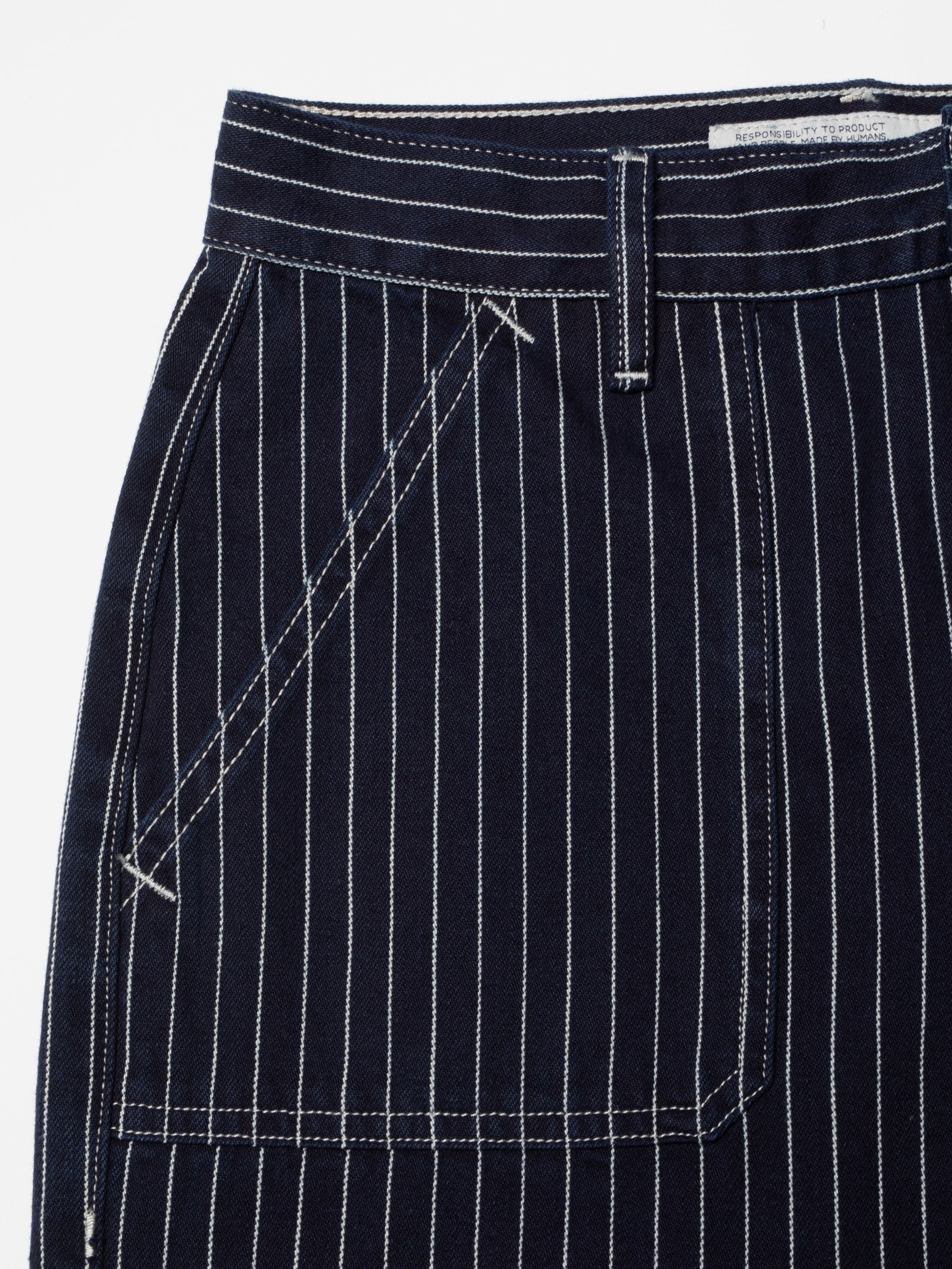 Nudie Jeans Asta Pants Pinstripe Denim, close-up of the front pocket and white pinstripes on blue rigid organic cotton denim.