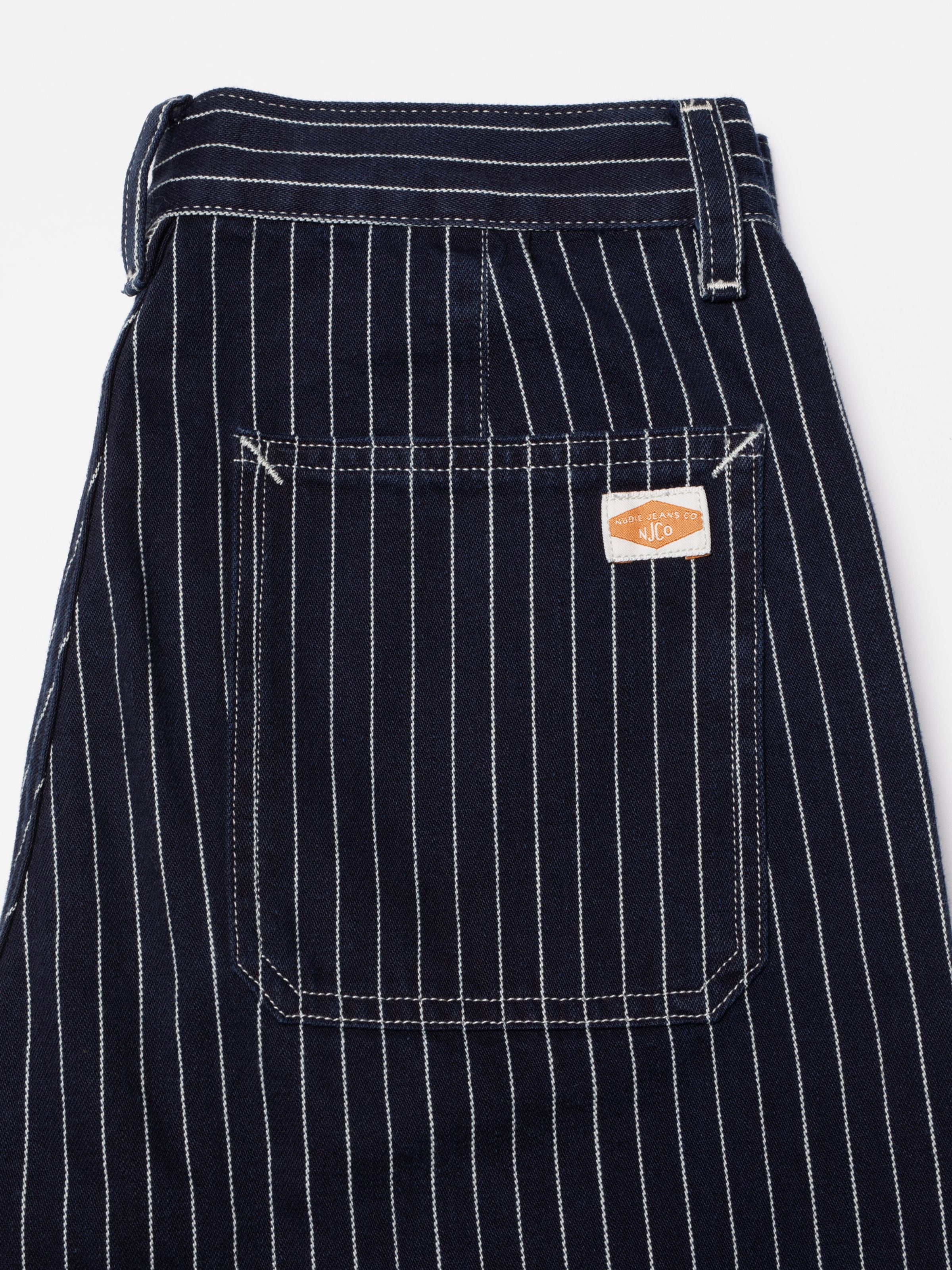 Nudie Jeans Asta Pants Pinstripe Denim, showing a close-up of the back pocket and rigid denim texture.
