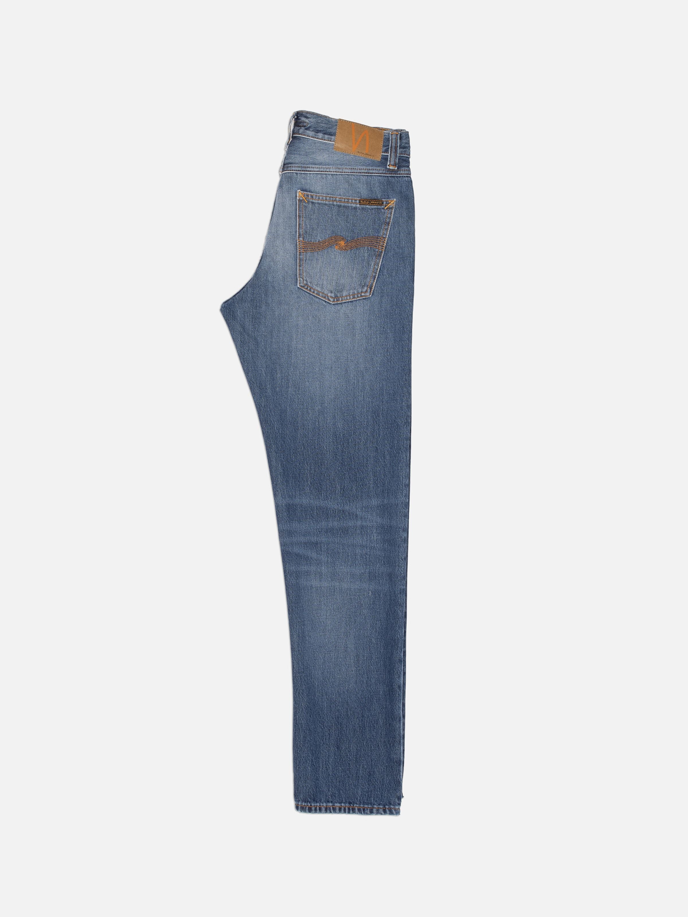 Nudie Jeans Steady Eddie II Rain River, mid blue regular tapered fit jeans shown from the side with orange stitching.