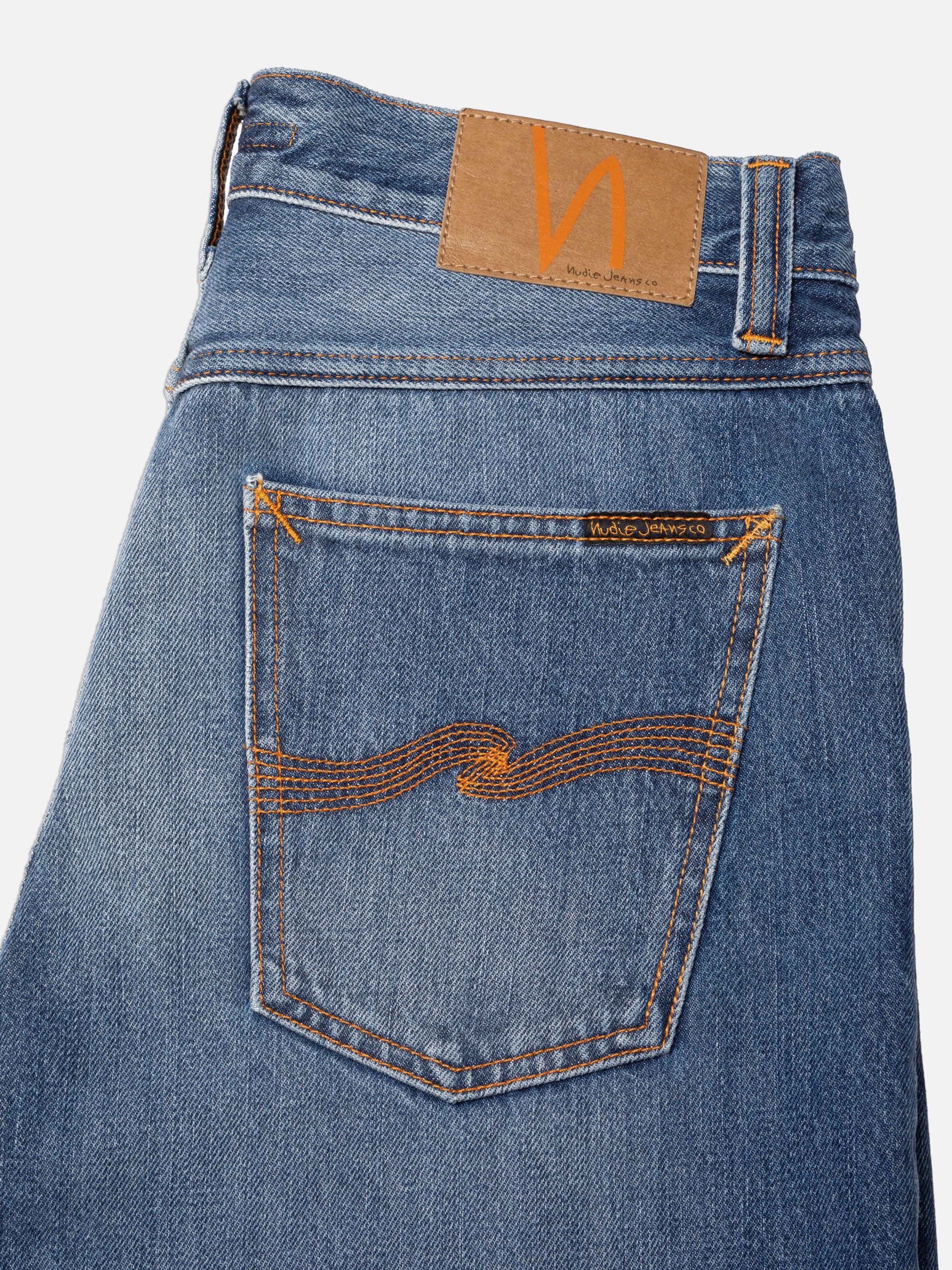 Nudie Jeans Steady Eddie II Rain River, back pocket, jacron patch, and orange stitching.