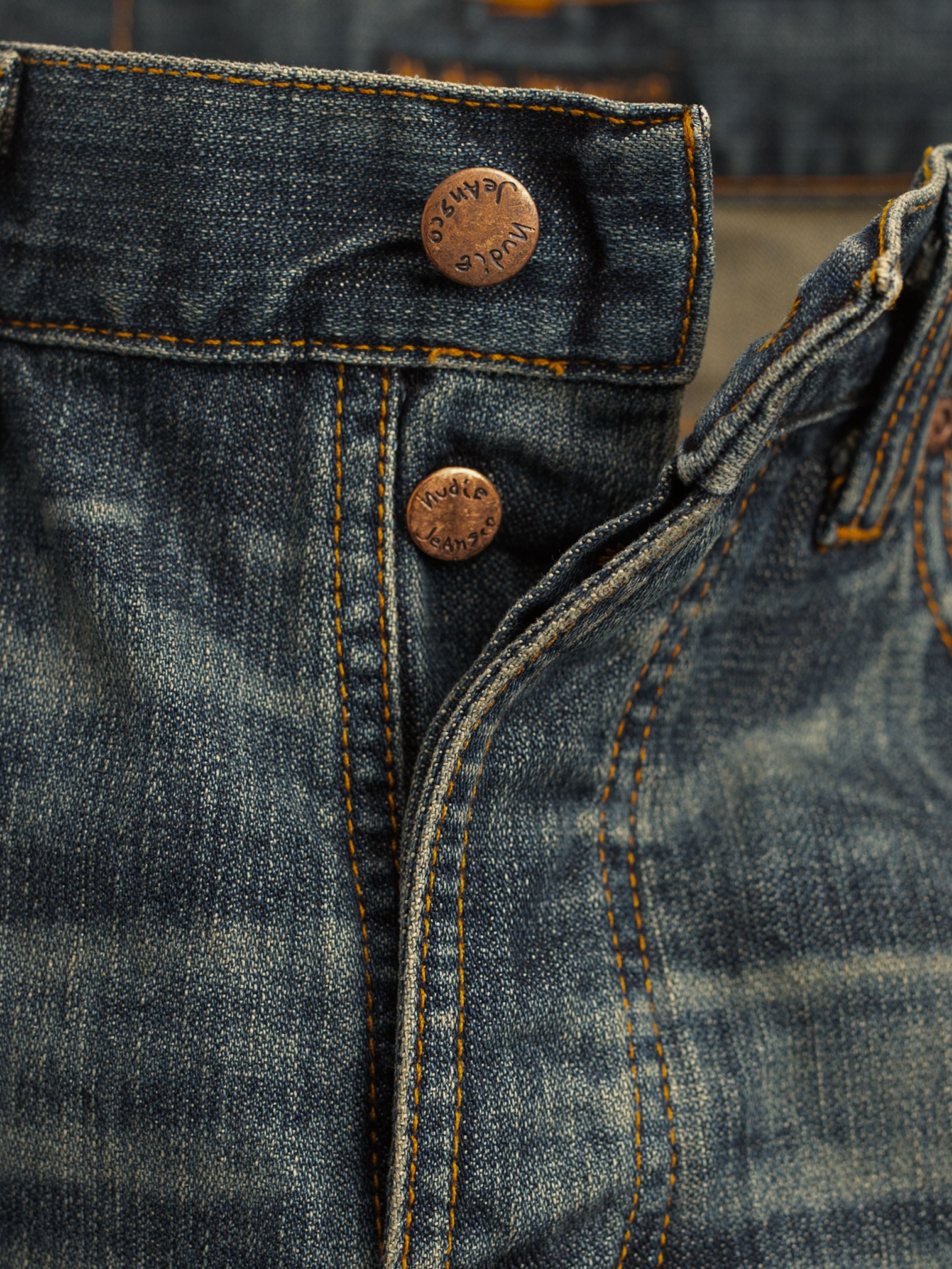 Nudie Jeans Steady Eddie II Quarter Tracks, men's regular fit jeans, showing a close-up of the button fly and copper trims.