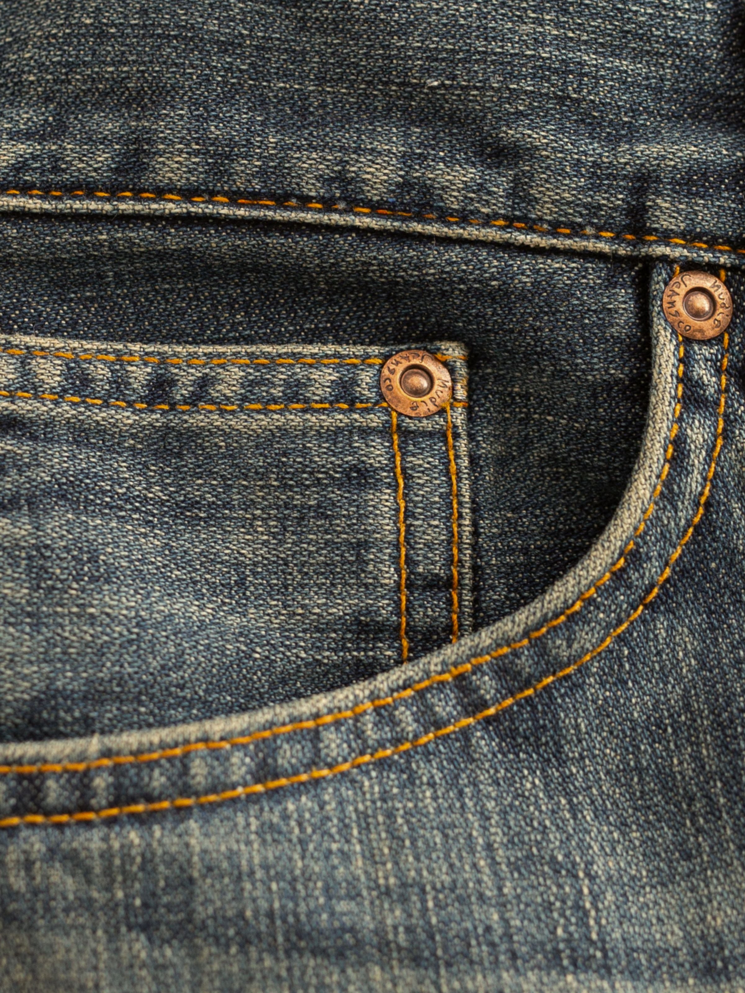 Nudie Jeans Steady Eddie II Quarter Tracks, showing a close-up of the coin pocket, copper trims, and washed denim texture.
