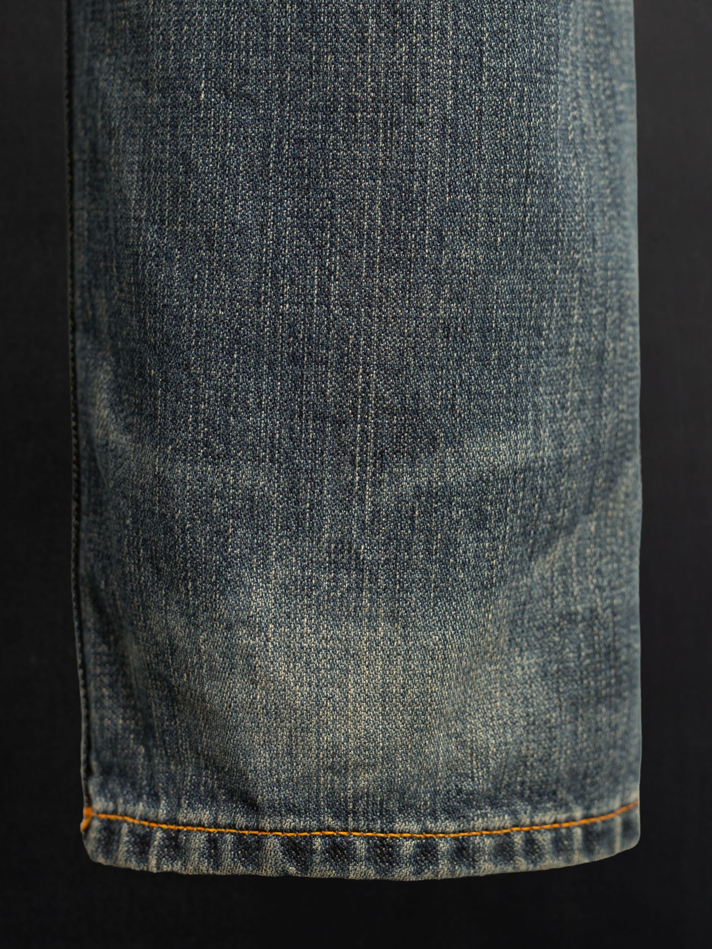 Nudie Jeans Steady Eddie II Quarter Tracks, showing a close-up of the washed denim leg texture.