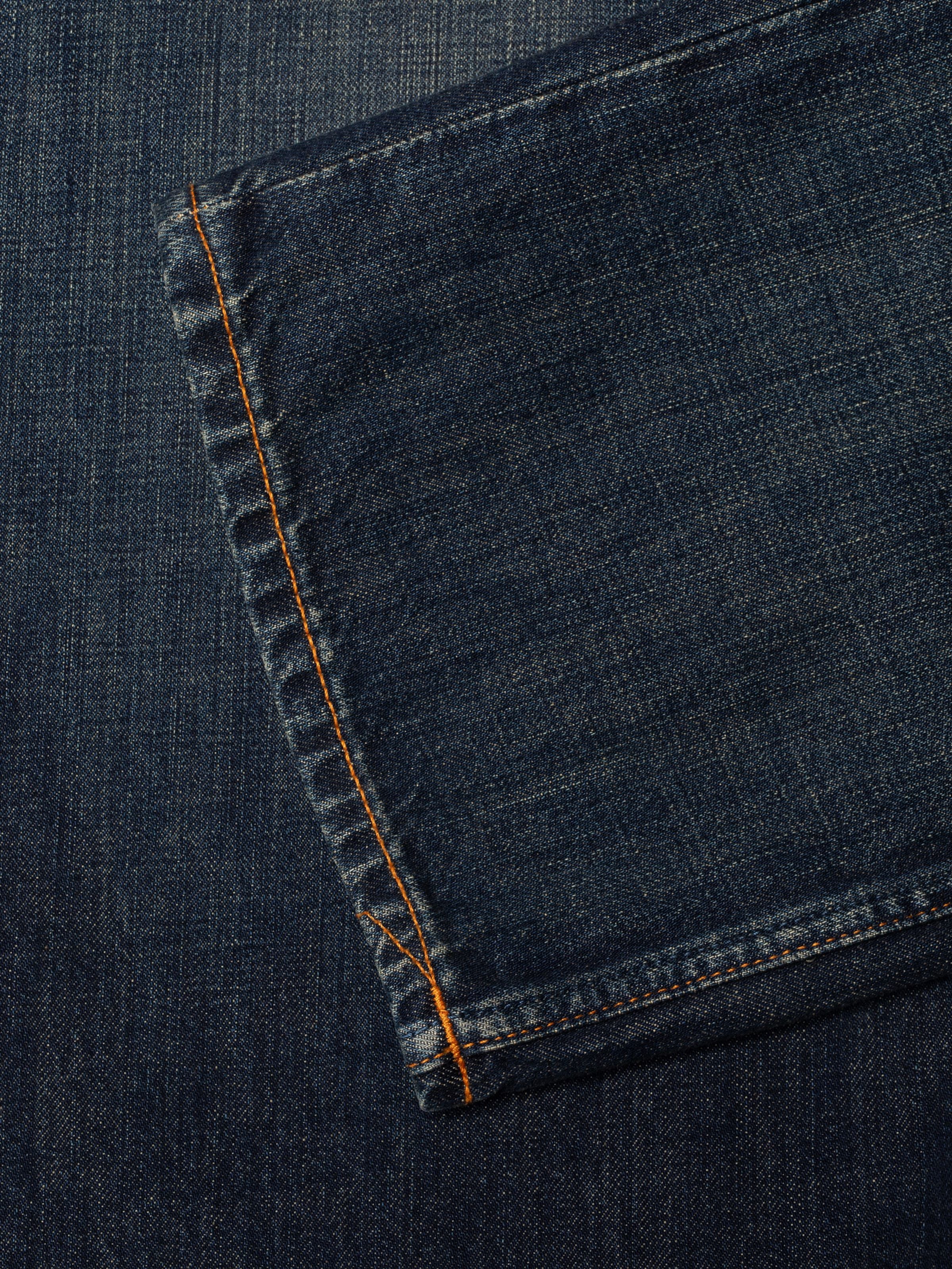 Nudie Jeans Tuff Tony Dirt Path, showing a close-up of the hem and organic cotton denim texture.