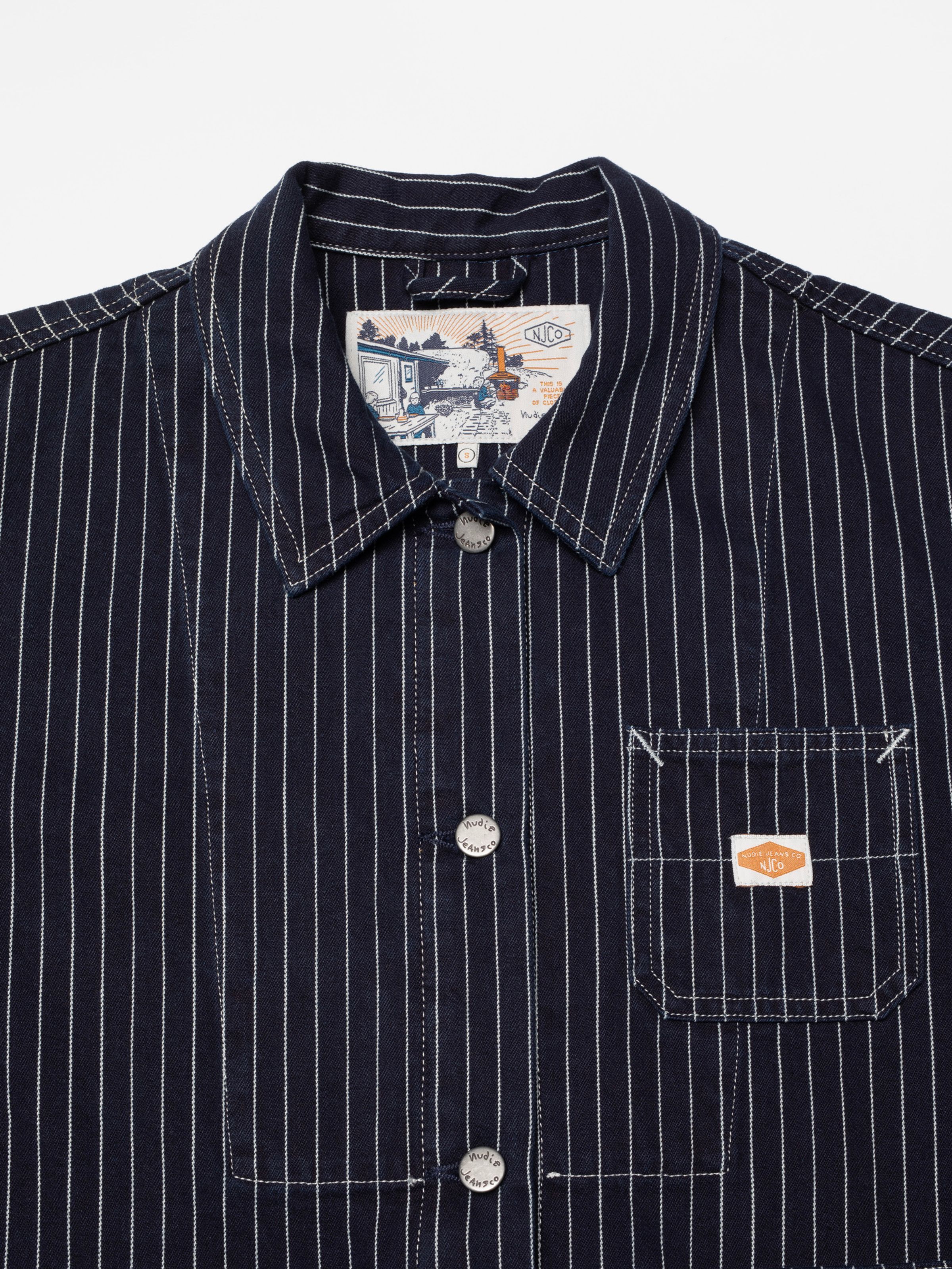 Nudie Jeans Ada Jacket Pinstripe Denim, close-up of collar, buttons, and pocket in pinstripe denim.