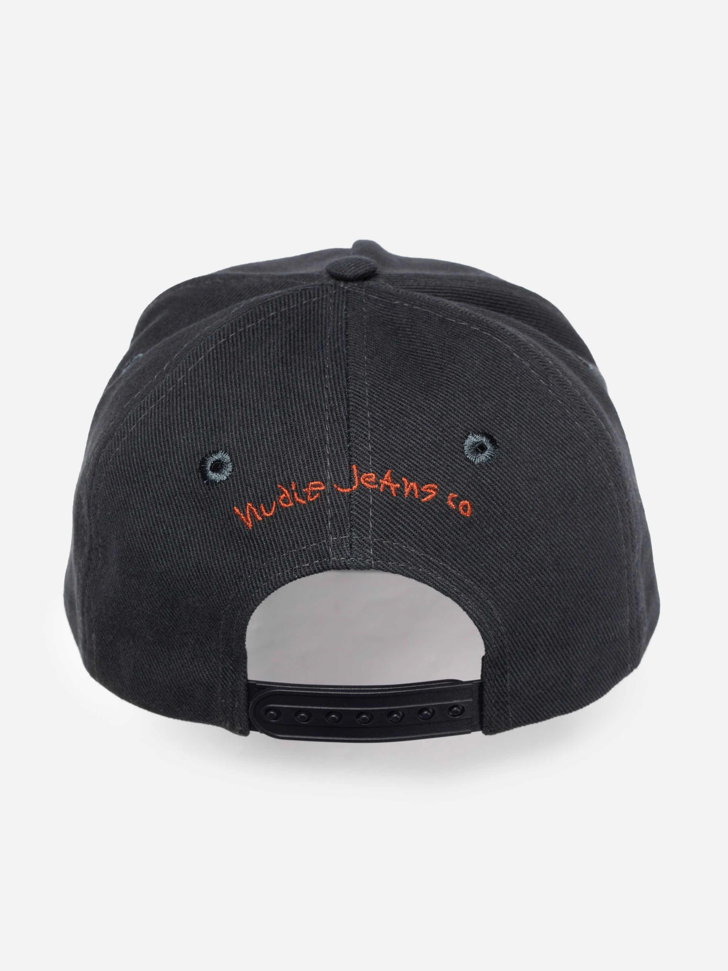 Nudie Cap Make Sense in black organic cotton, showing the back view with orange embroidery and a snapback closure.