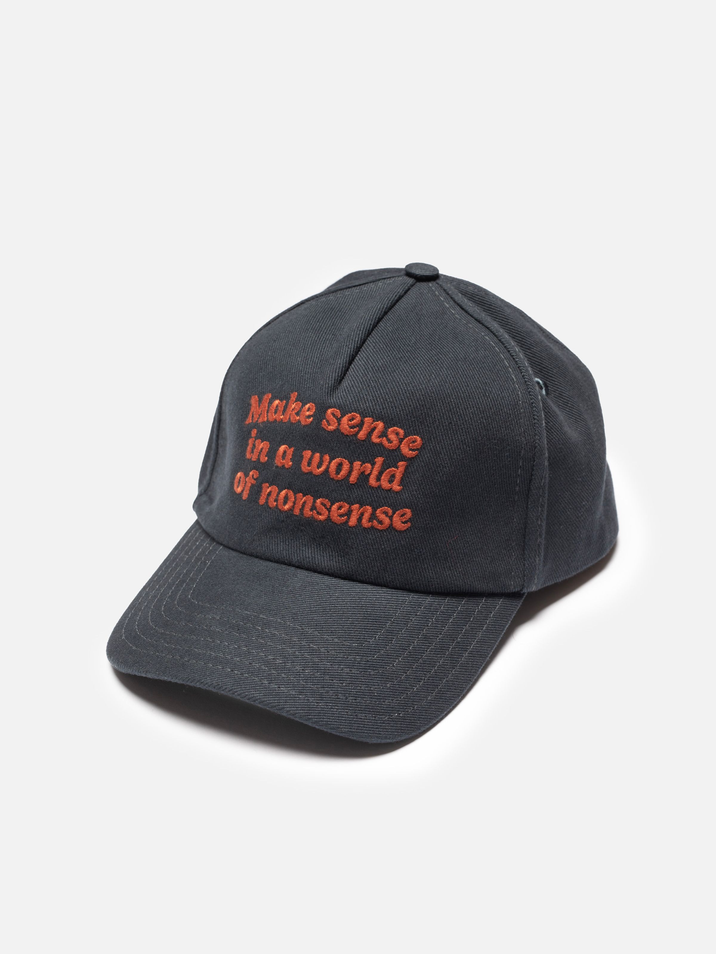 Nudie Jeans Nudie Cap Make Sense, a black organic cotton cap with red front embroidery and five-panel construction.