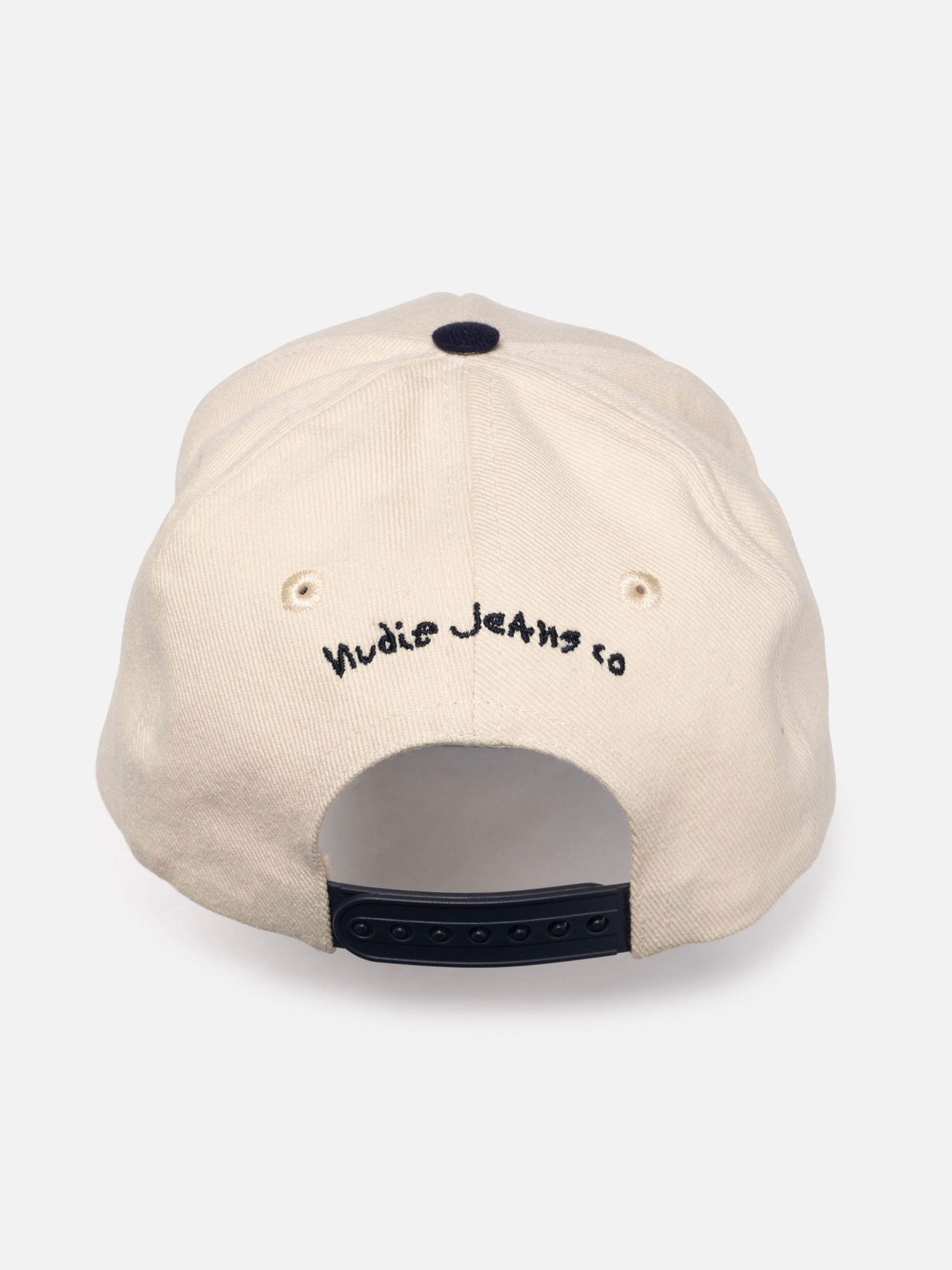 Nudie Cap Embo in off-white organic cotton, back view showing black embroidery and adjustable snapback closure.