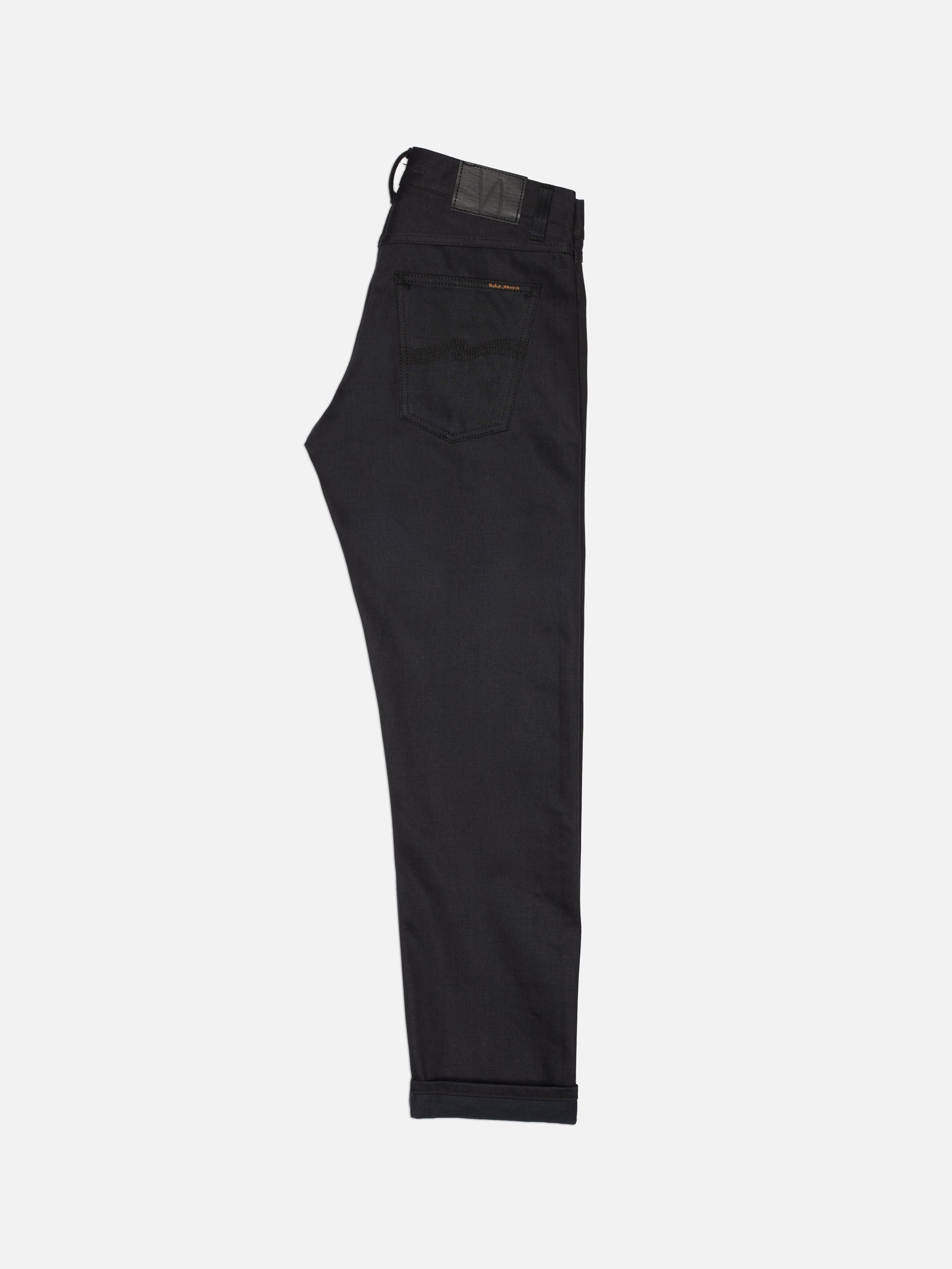 Nudie Jeans Gritty Jackson Dry Onyx Selvage, regular-fit rigid black jeans shown from the back against a white background.