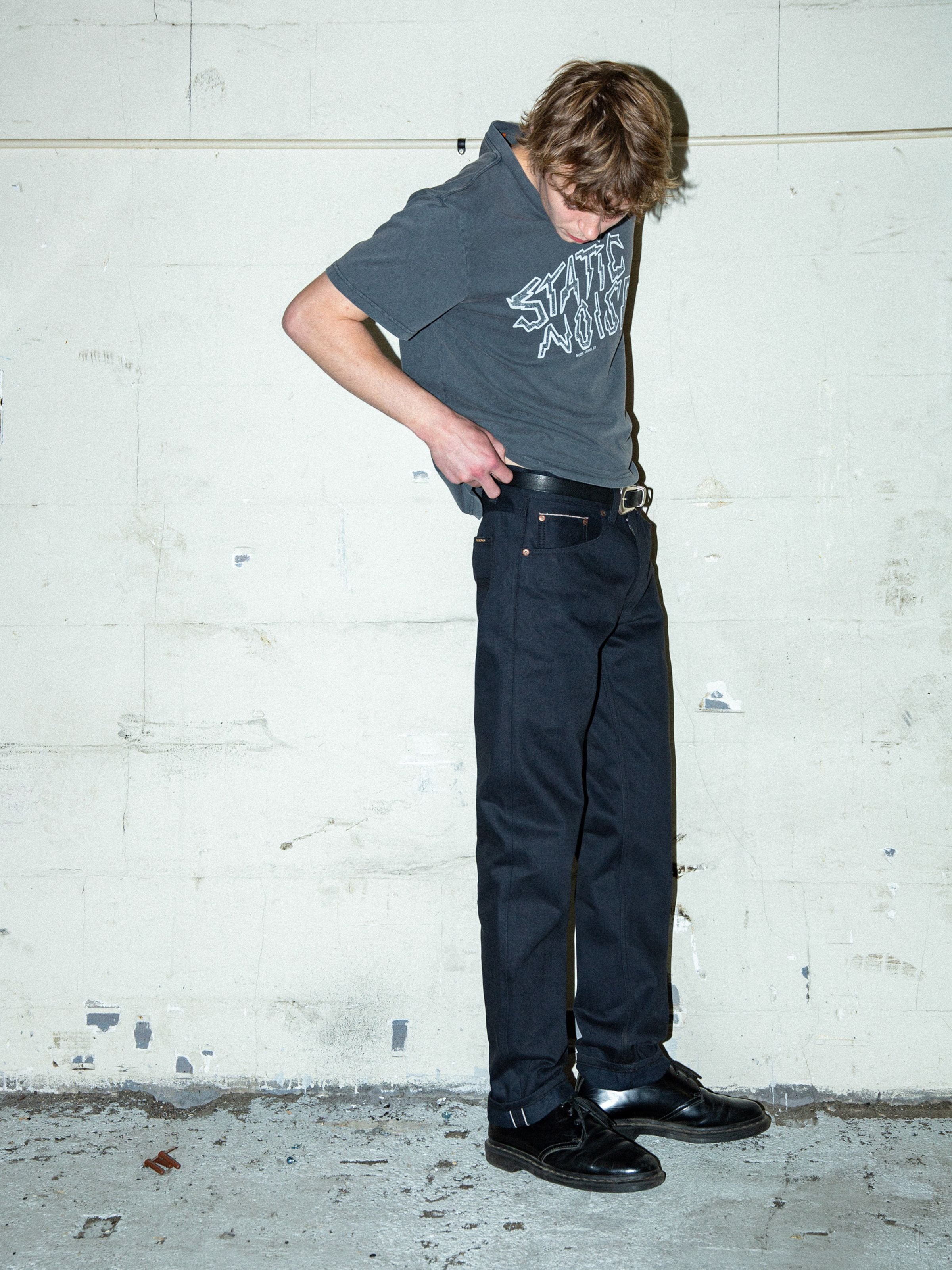 Gritty Jackson Dry Onyx Selvedge, men's rigid selvedge jeans in black, lifestyle full shot.