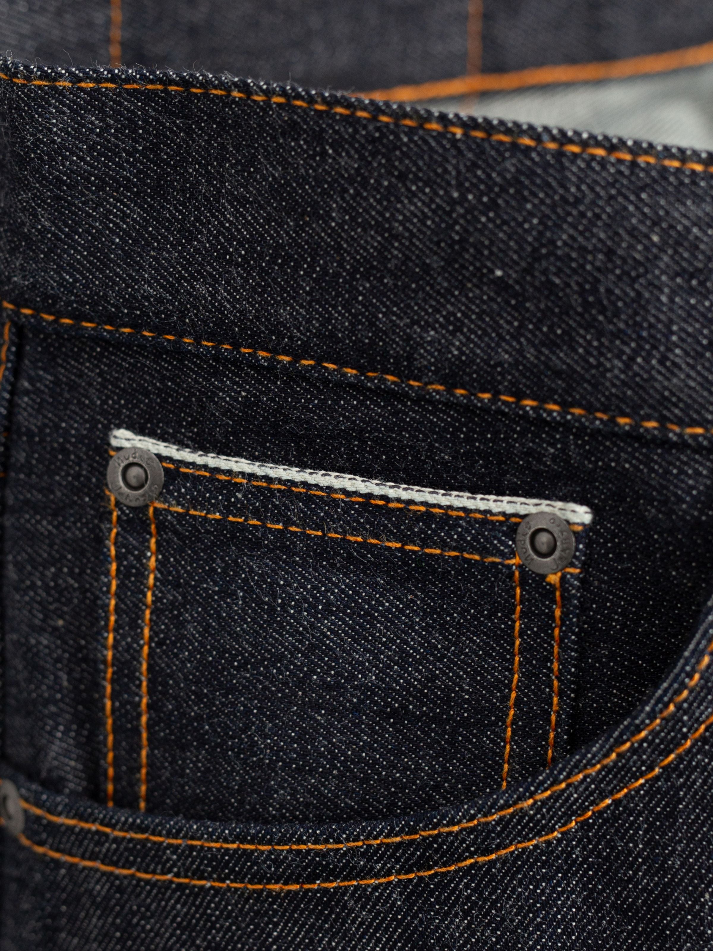 Solid Ollie Dry Apex Selvage, slim fit jeans, showing a close-up of the front coin pocket and orange thread stitching.