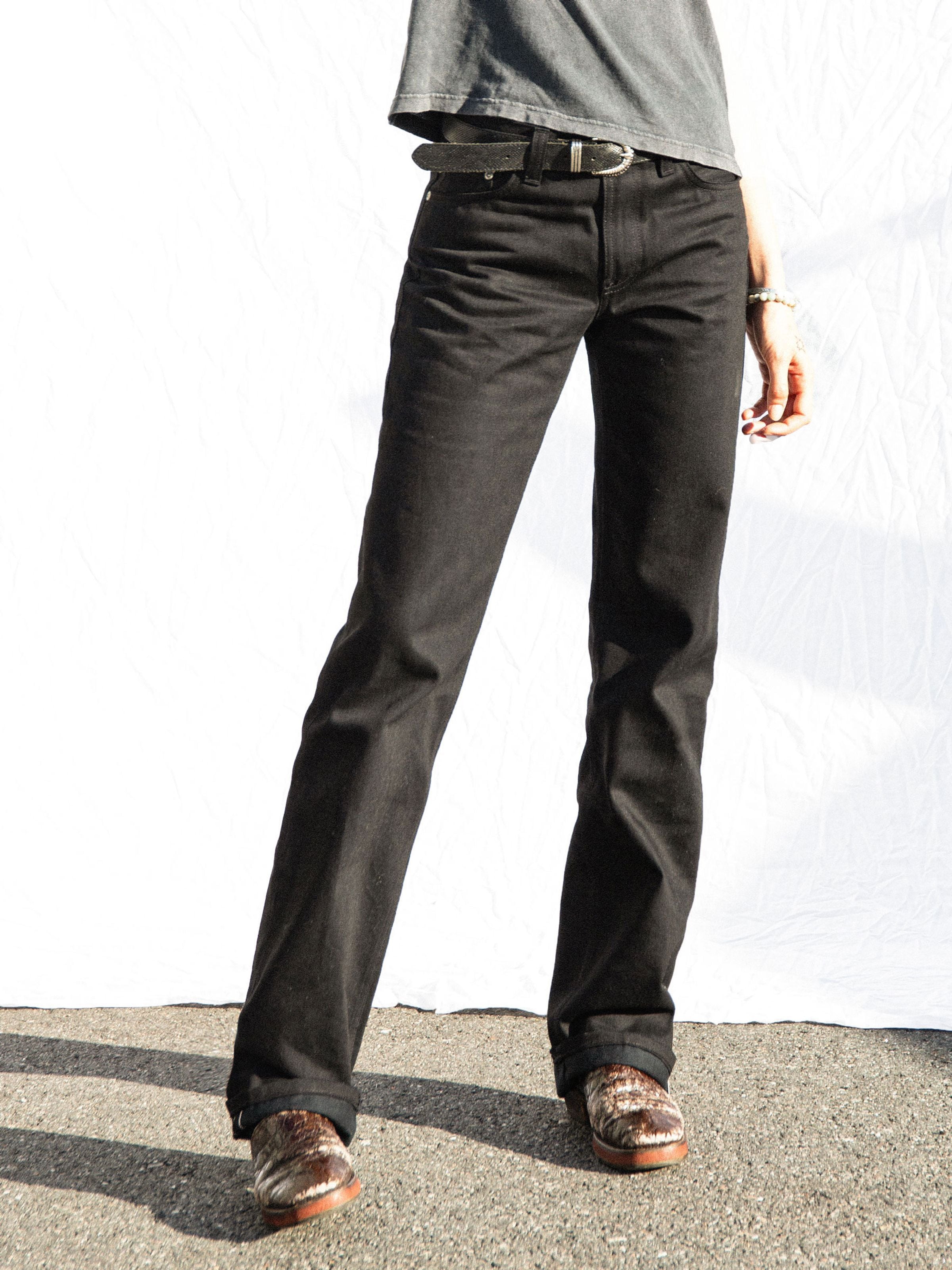 Nudie Jeans Sharp Charlie Space Black Selvedge, women's straight fit jeans, shown in a lifestyle shot wearing black denim.