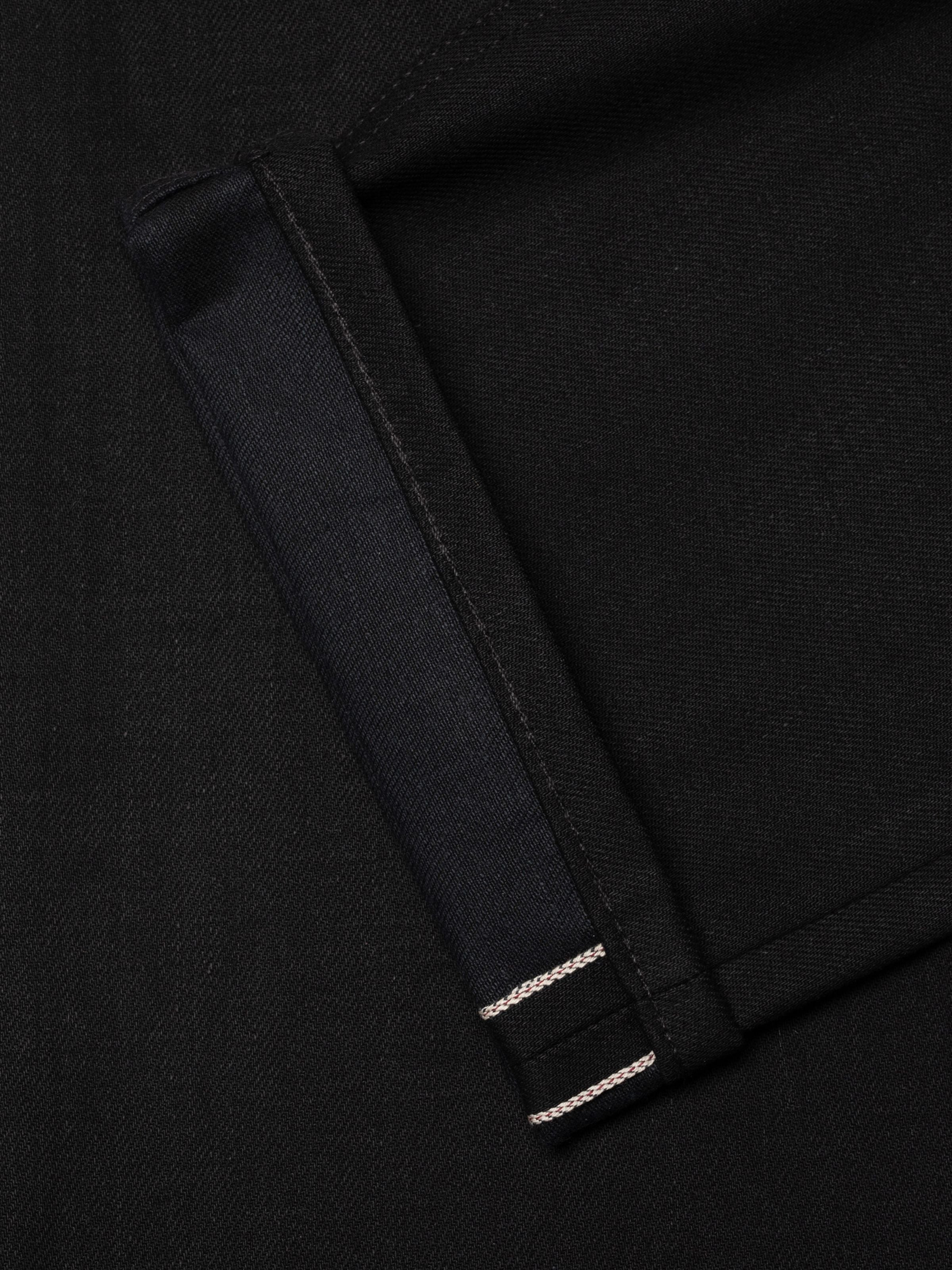 Nudie Jeans Sharp Charlie Space Black Selvage, women's jeans, close-up of the black selvedge hem.