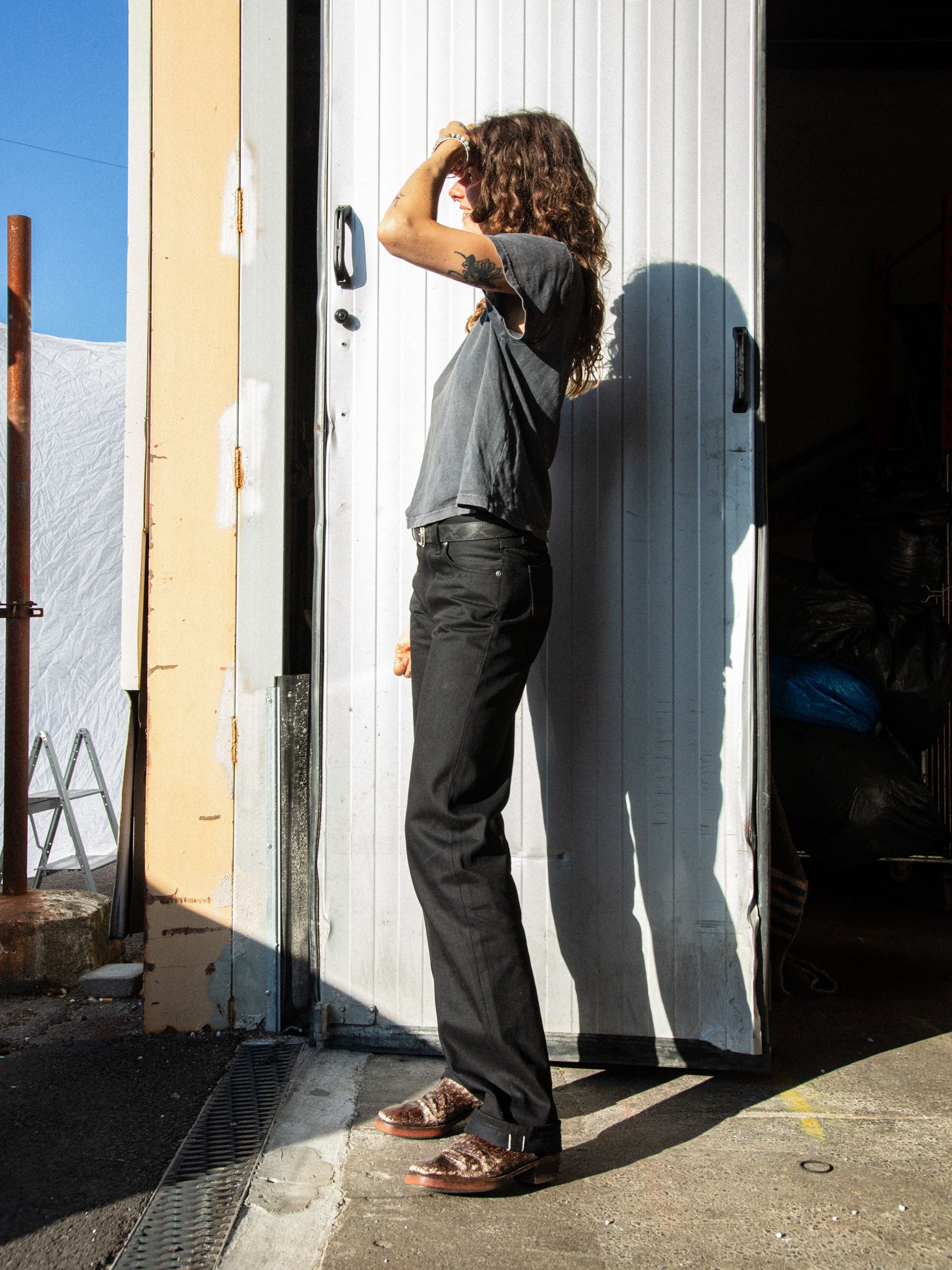 Nudie Jeans Sharp Charlie Space Black Selvedge, Damenjeans in Schwarz, Seitenansicht in voller Länge.