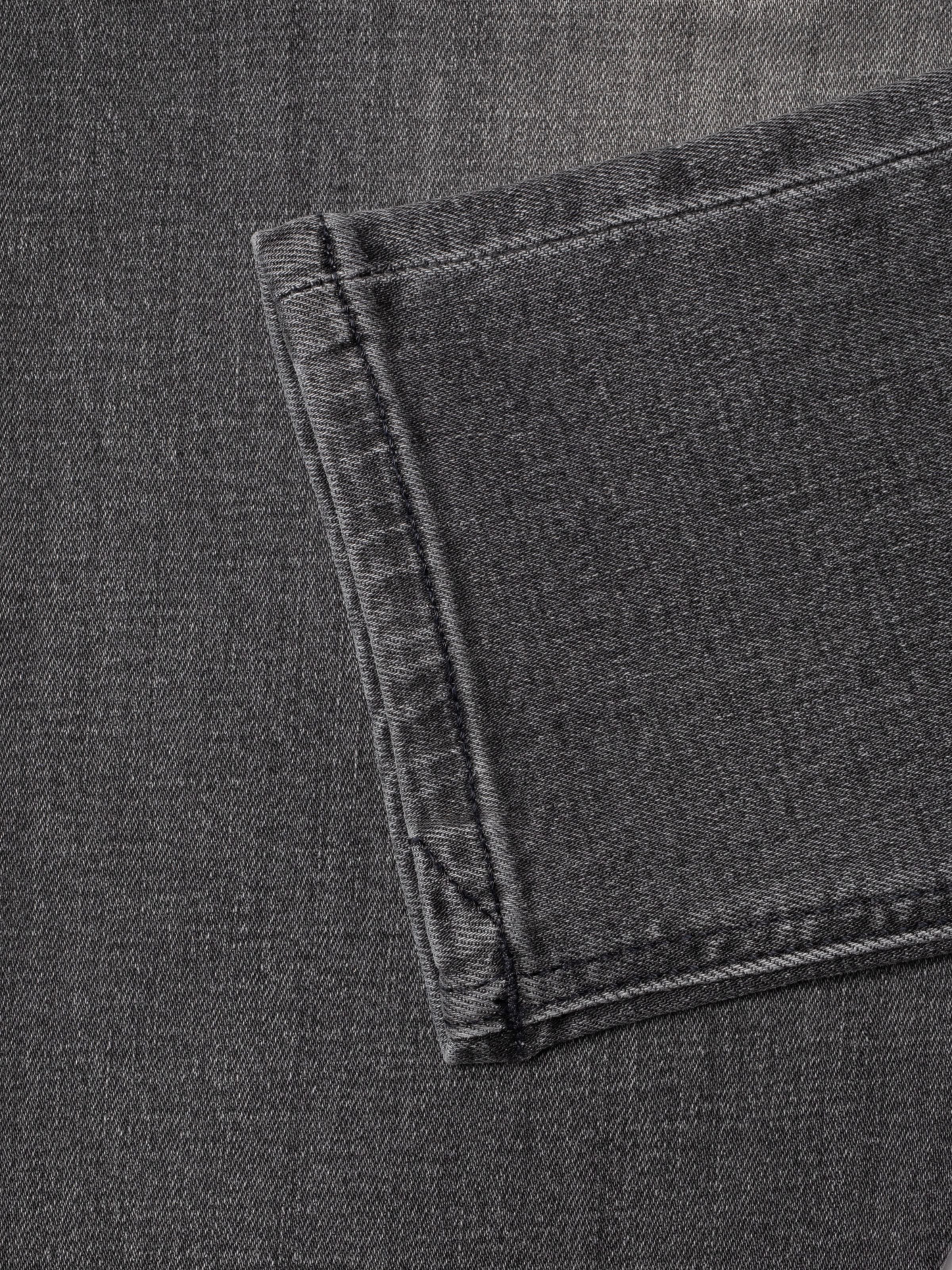 Nudie Jeans Tight Terry Grey Lava, showing a close-up of the hem and grey washed organic cotton denim texture.