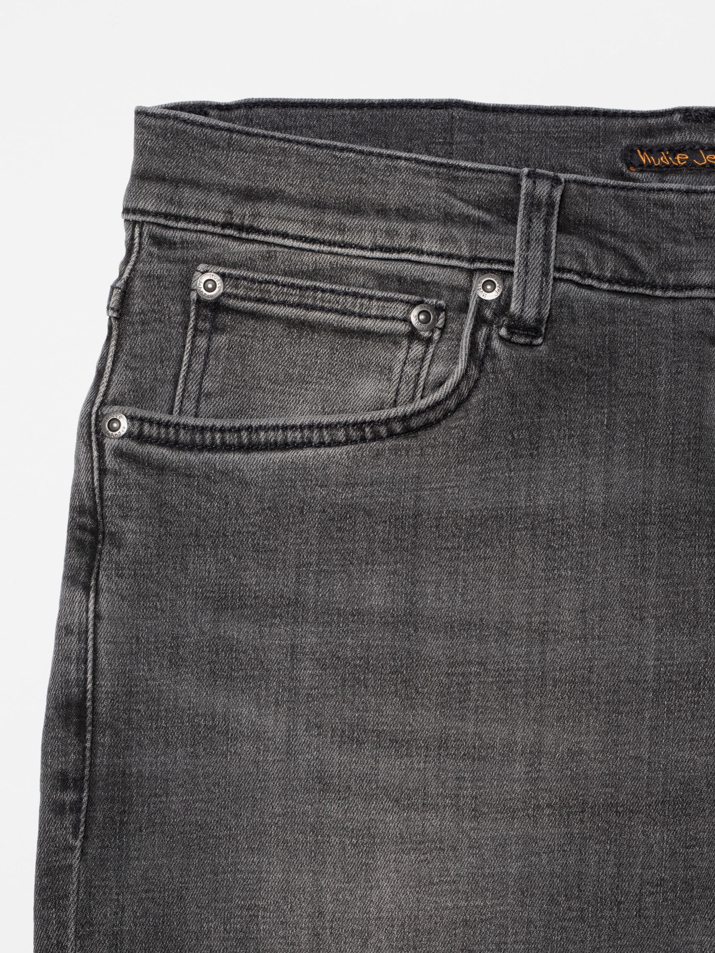 Nudie Jeans Tight Terry Grey Lava, men's tight fit jeans, showing a close-up of the front pocket and washed denim texture.
