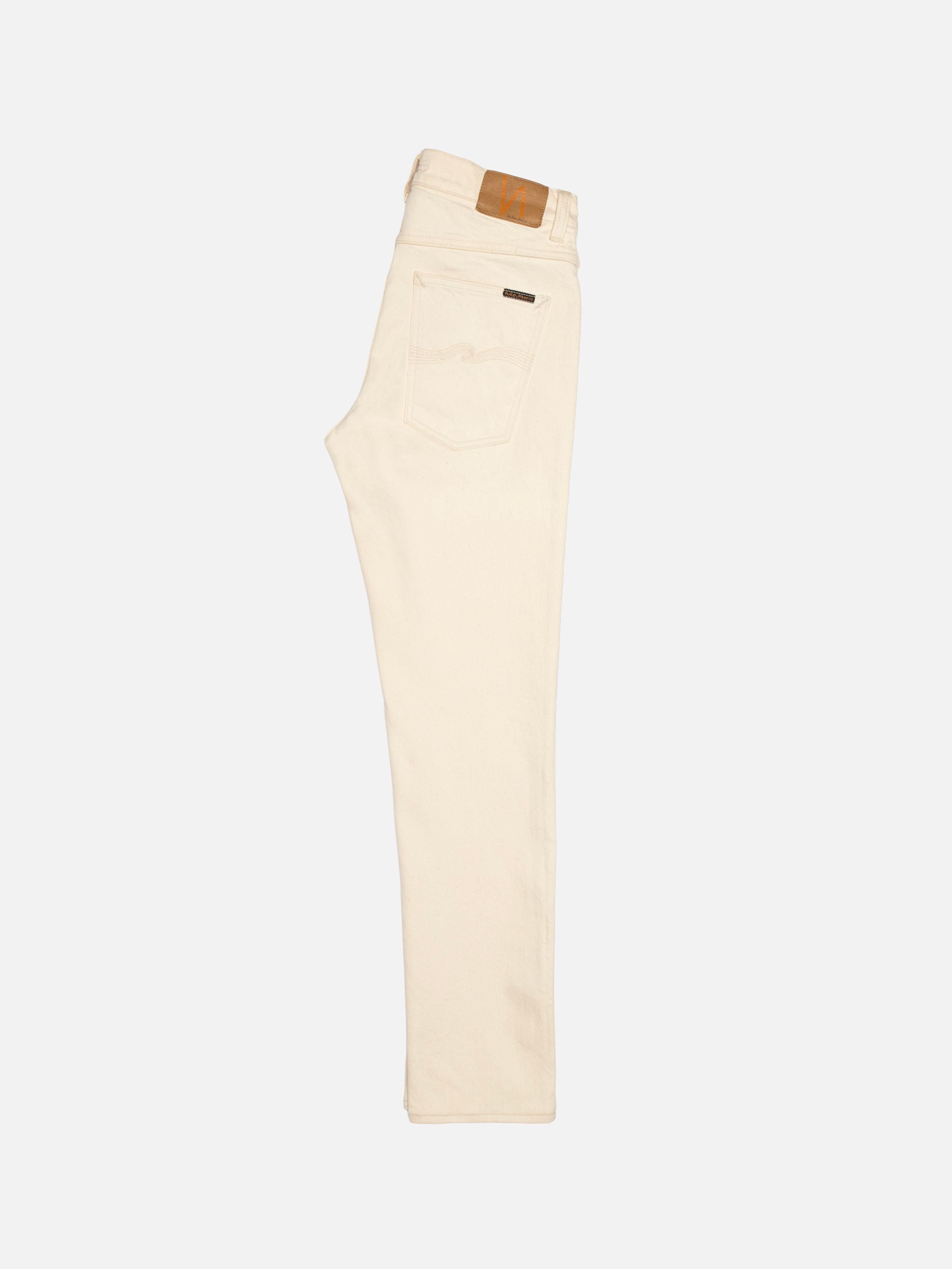 Nudie Jeans Lean Dean Ivory, slim fit tapered jeans in ivory organic cotton stretch denim, shown laid flat from the side.