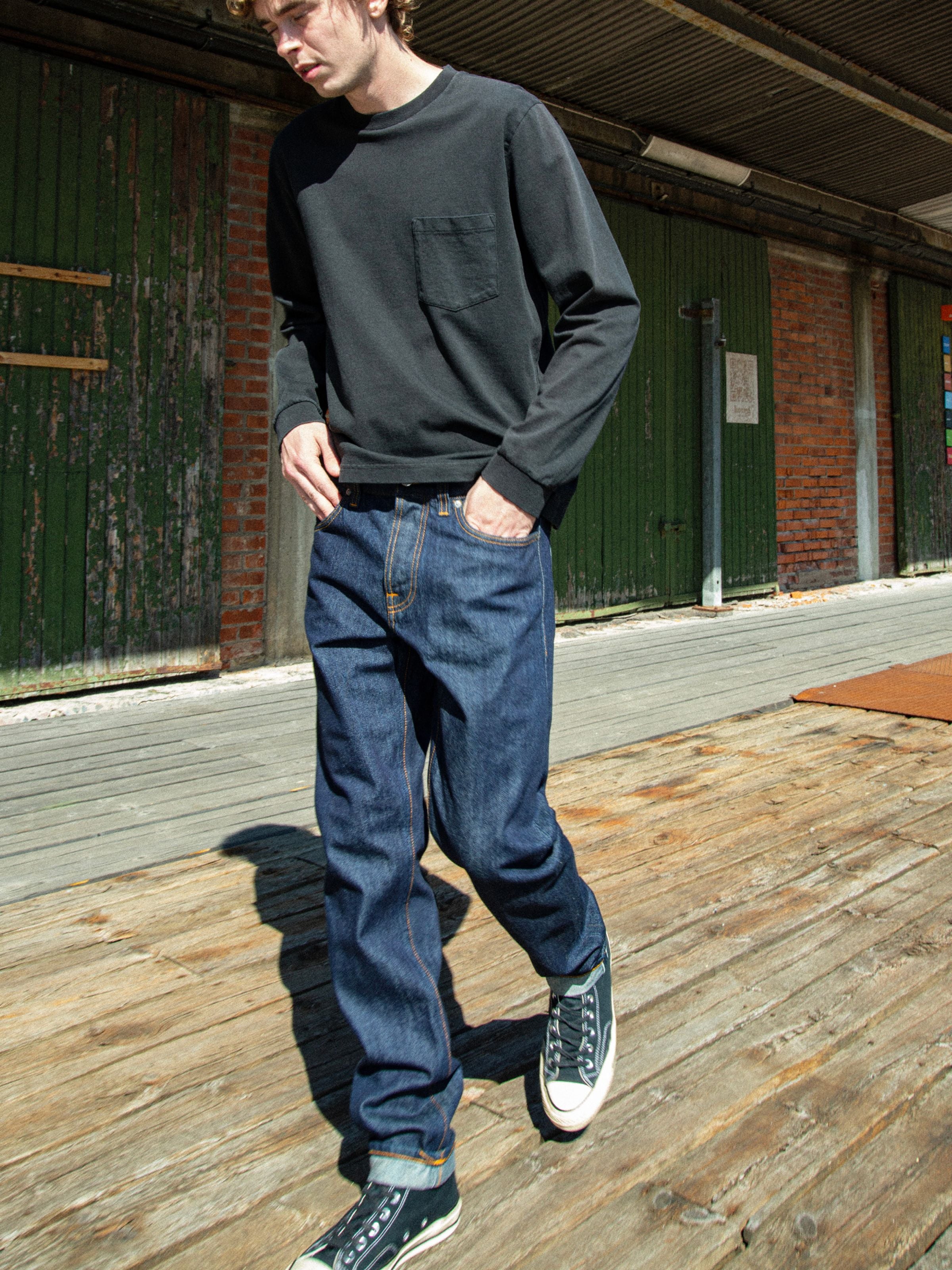 Nudie Jeans Steady Eddie II Dusk Selvage One Wash, men's regular fit jeans, worn outdoors in a lifestyle setting.