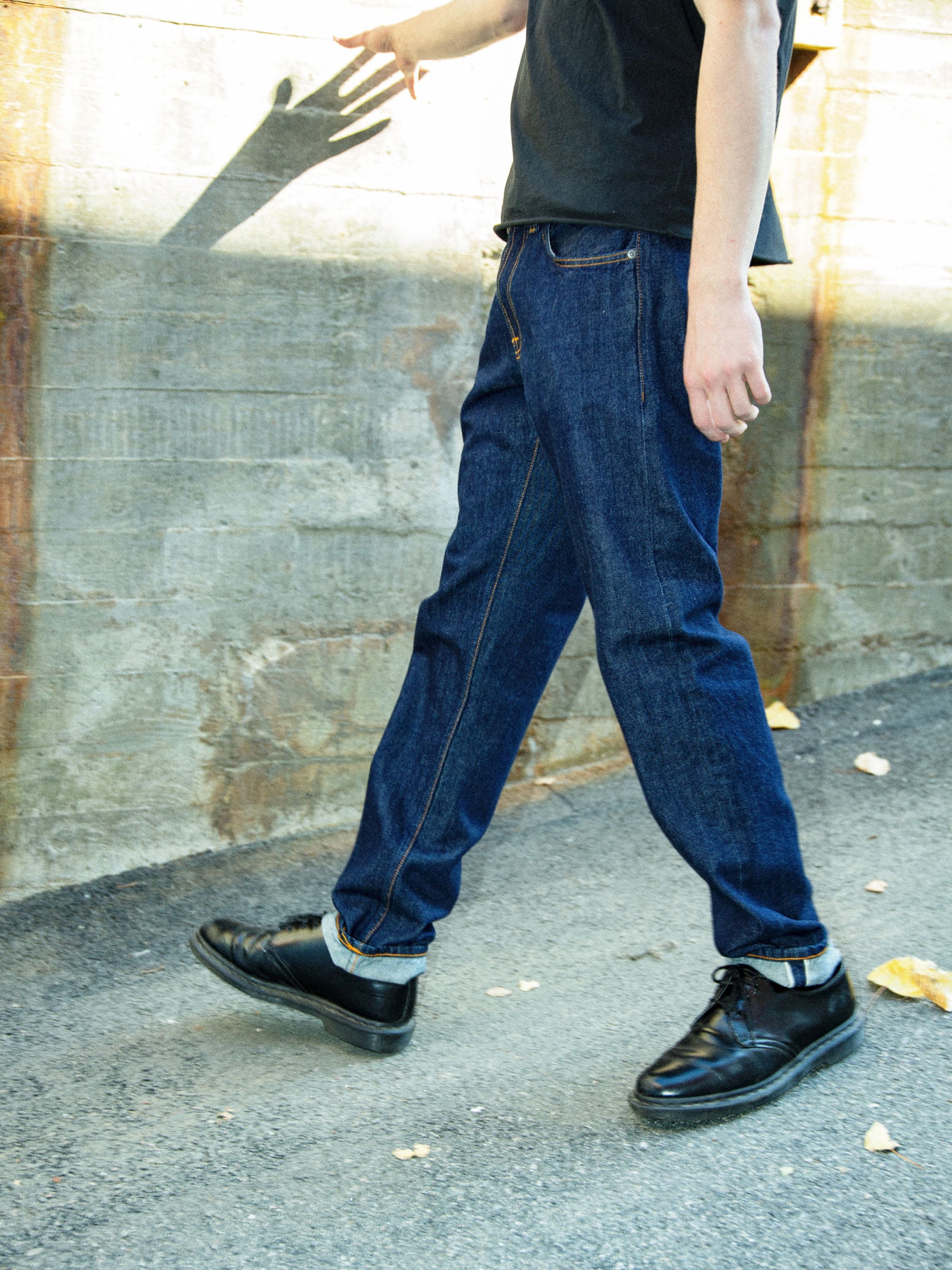 Nudie Jeans Gritty Jackson Dusk Selvage One Wash, men's regular fit jeans worn outdoors in a lifestyle shot.