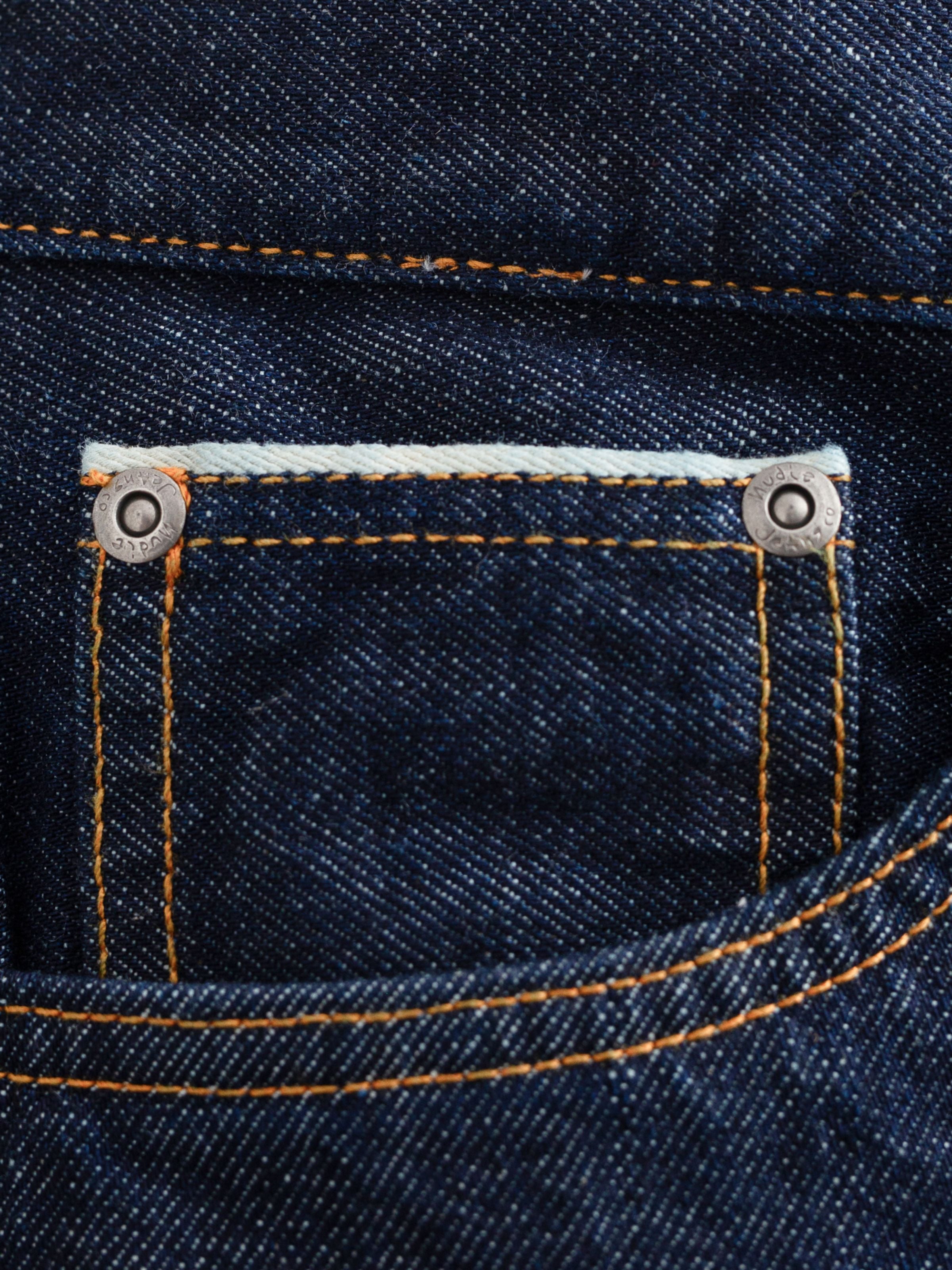 Gritty Jackson Dusk Selvage One Wash, close-up of front pocket, orange stitching, and selvedge denim texture.