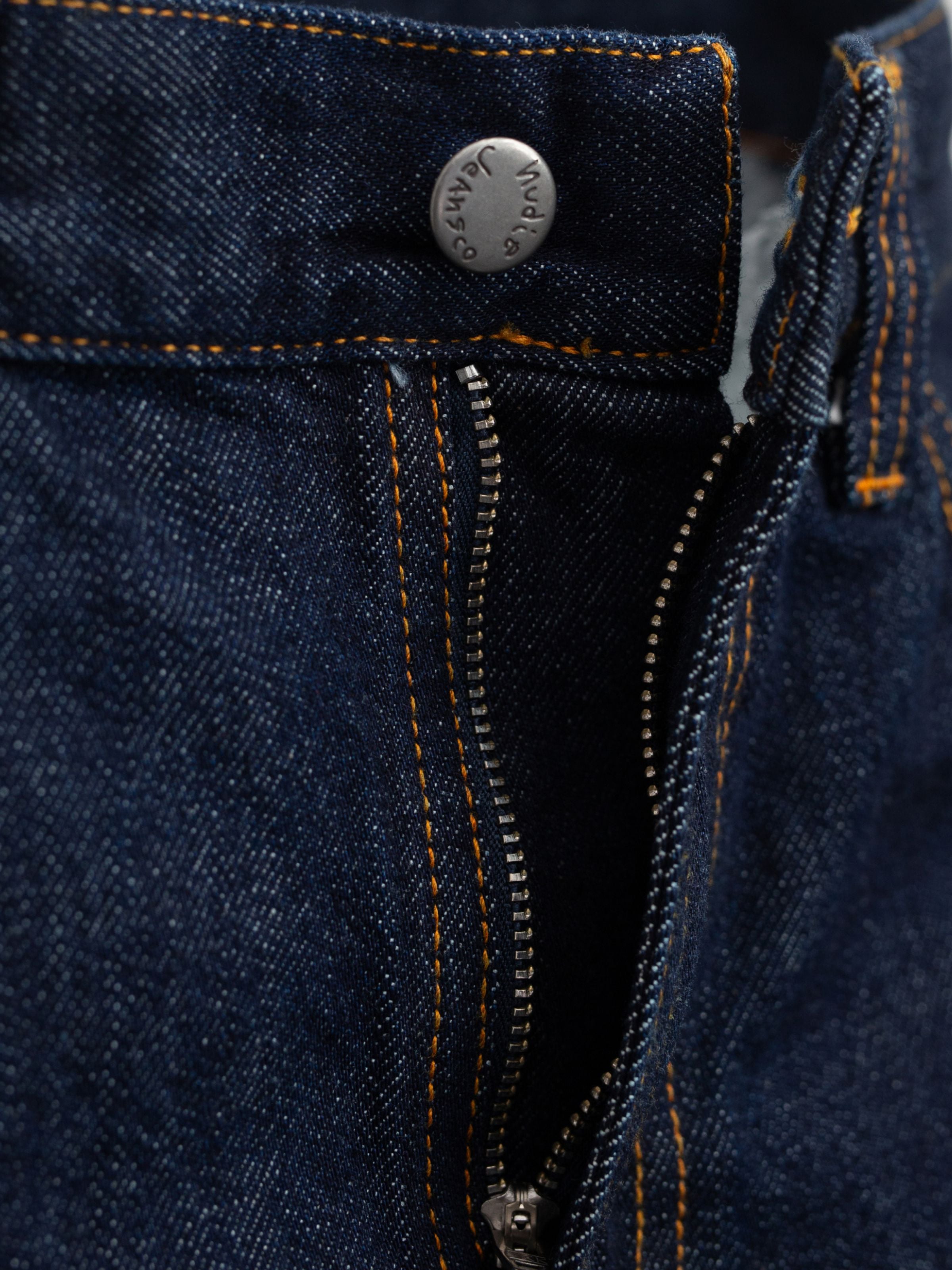 Nudie Jeans Gritty Jackson Dusk Selvage One Wash, men's regular fit jeans, showing a close-up of the zip fly and button.