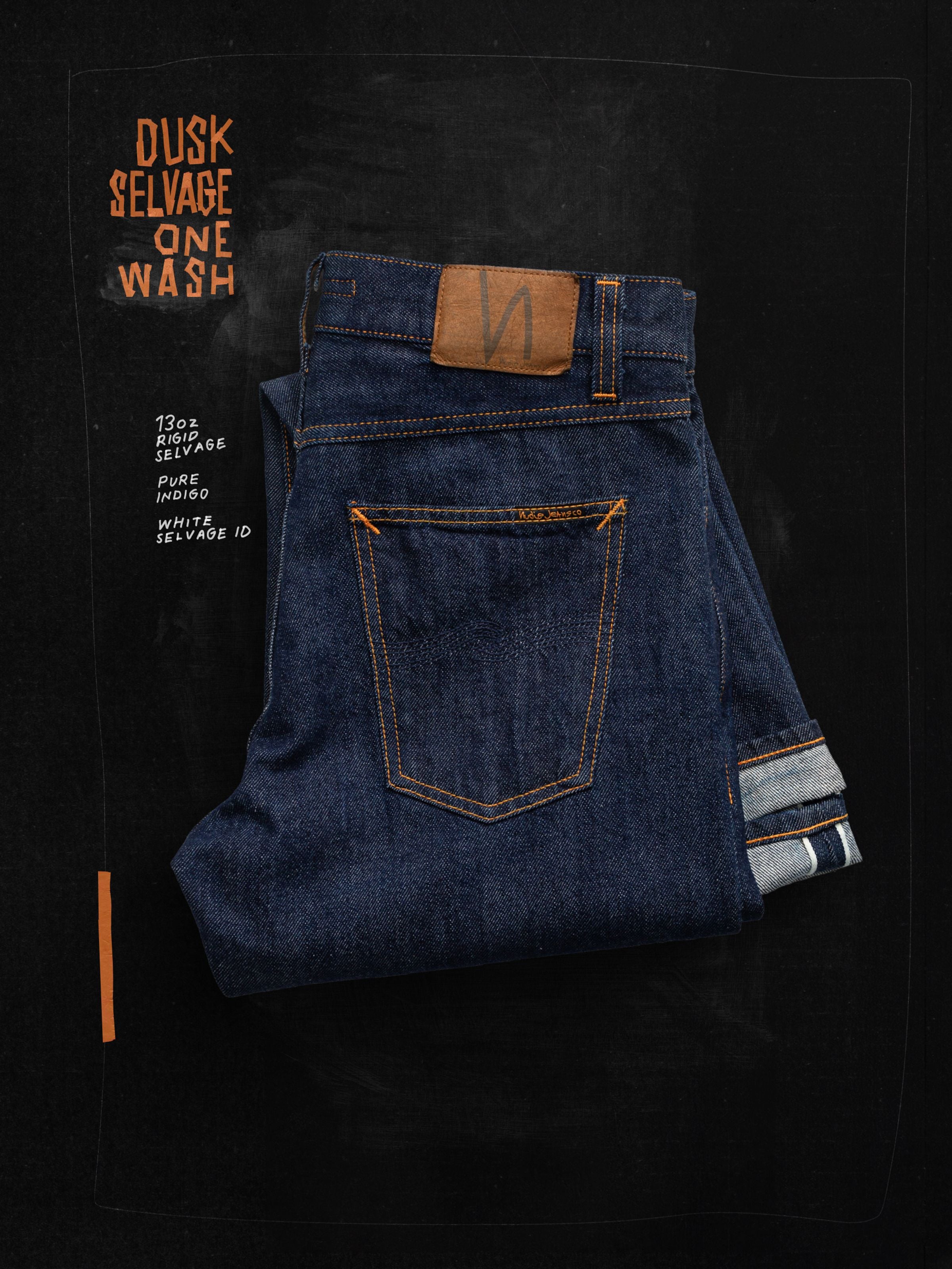 Nudie Jeans Gritty Jackson Dusk Selvage One Wash, regular fit jeans folded to show back pocket, jacron patch, and selvedge.